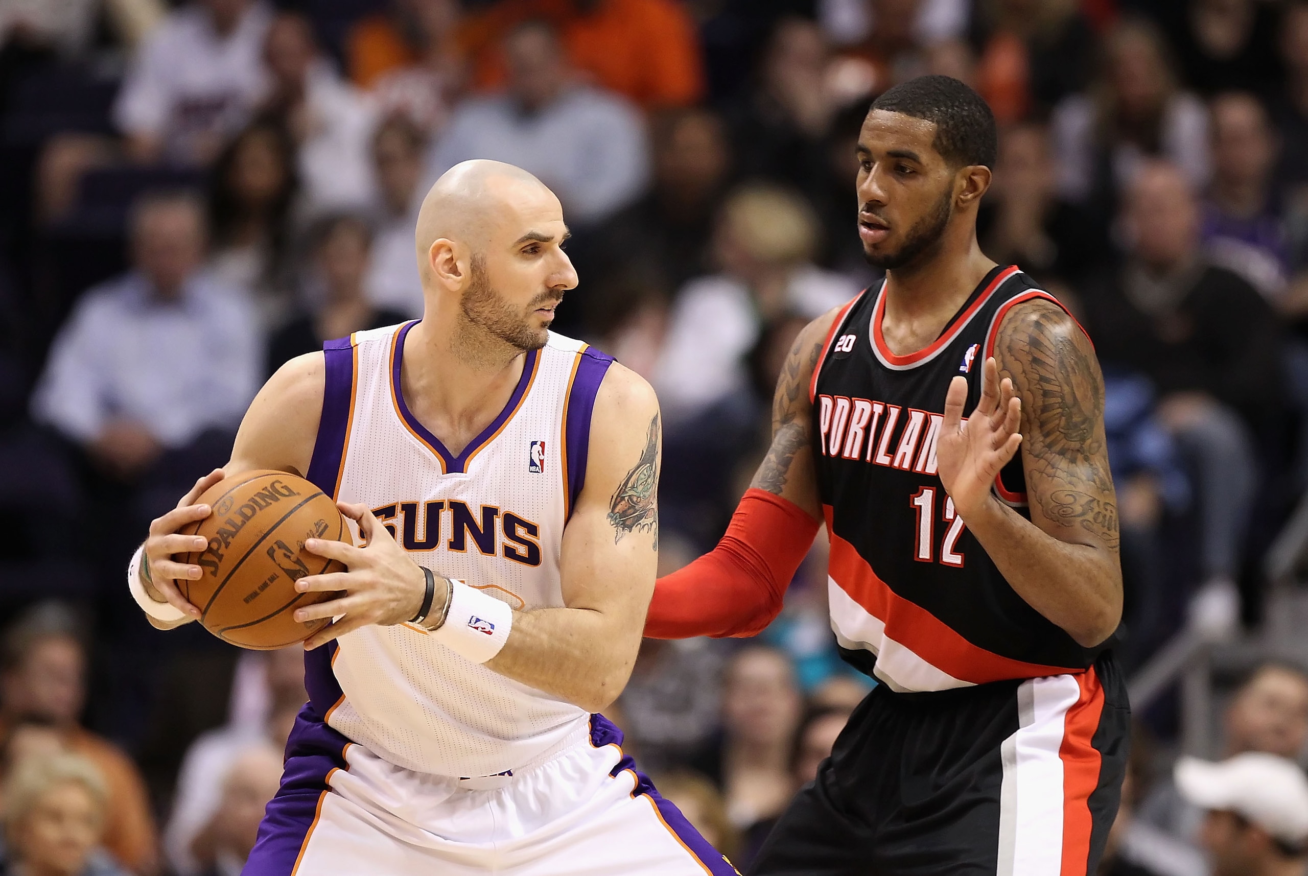 PHOENIX, AZ - JANUARY 14:  Marcin Gortat #4 of the Phoenix Suns looks to pass against LaMarcus Aldridge #12 of the Portland Trail Blazers during the NBA game at US Airways Center on January 14, 2011 in Phoenix, Arizona. The Suns defeated the Trail Blazers