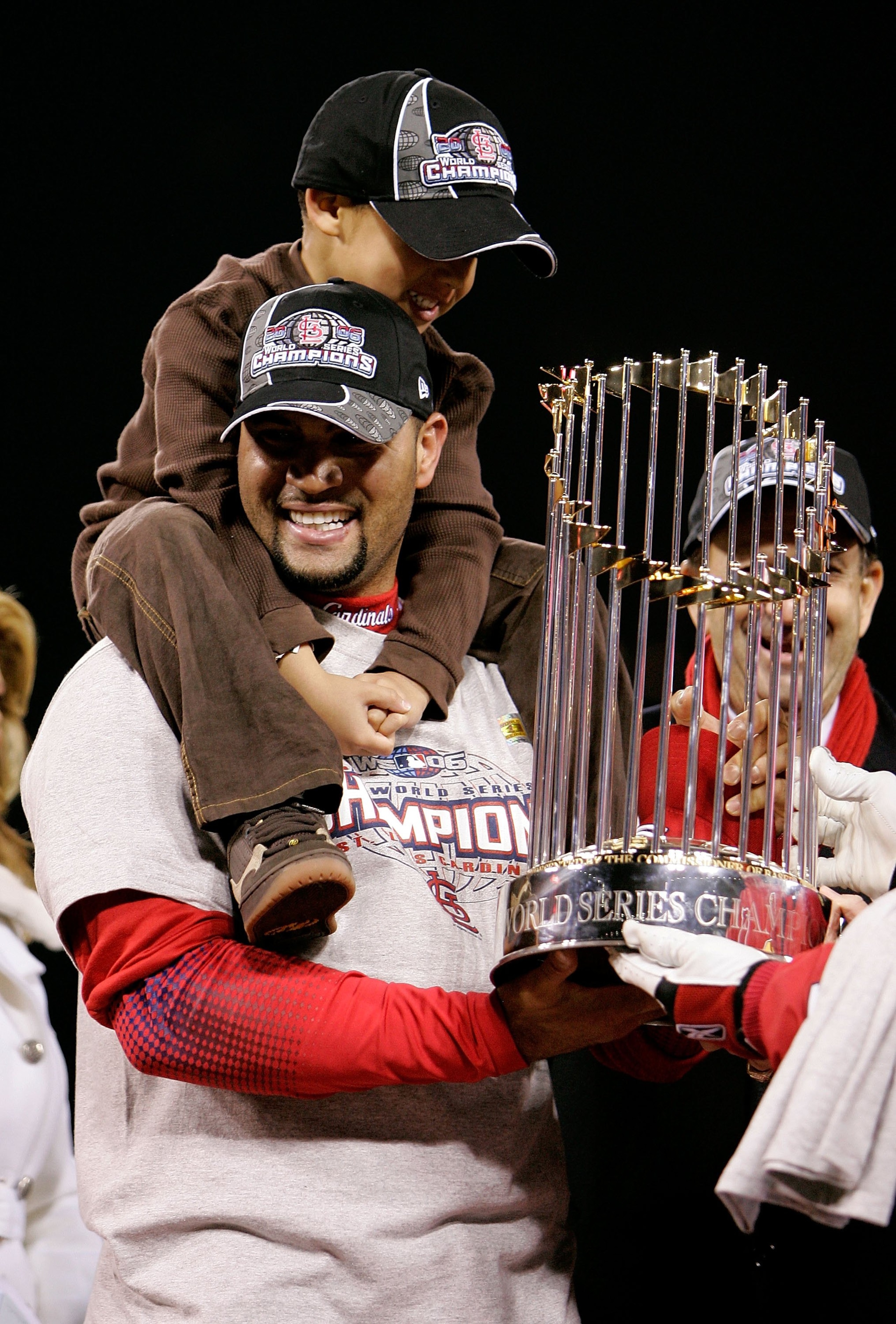 ST LOUIS, MO - OCTOBER 27:  Albert Pujols #5 of the St. Louis Cardinals and his son, AJ celebrate with the World Series Trophy after defeating the Detroit Tigers in Game Five of the 2006 World Series on October 27, 2006 at Busch Stadium in St. Louis, Miss