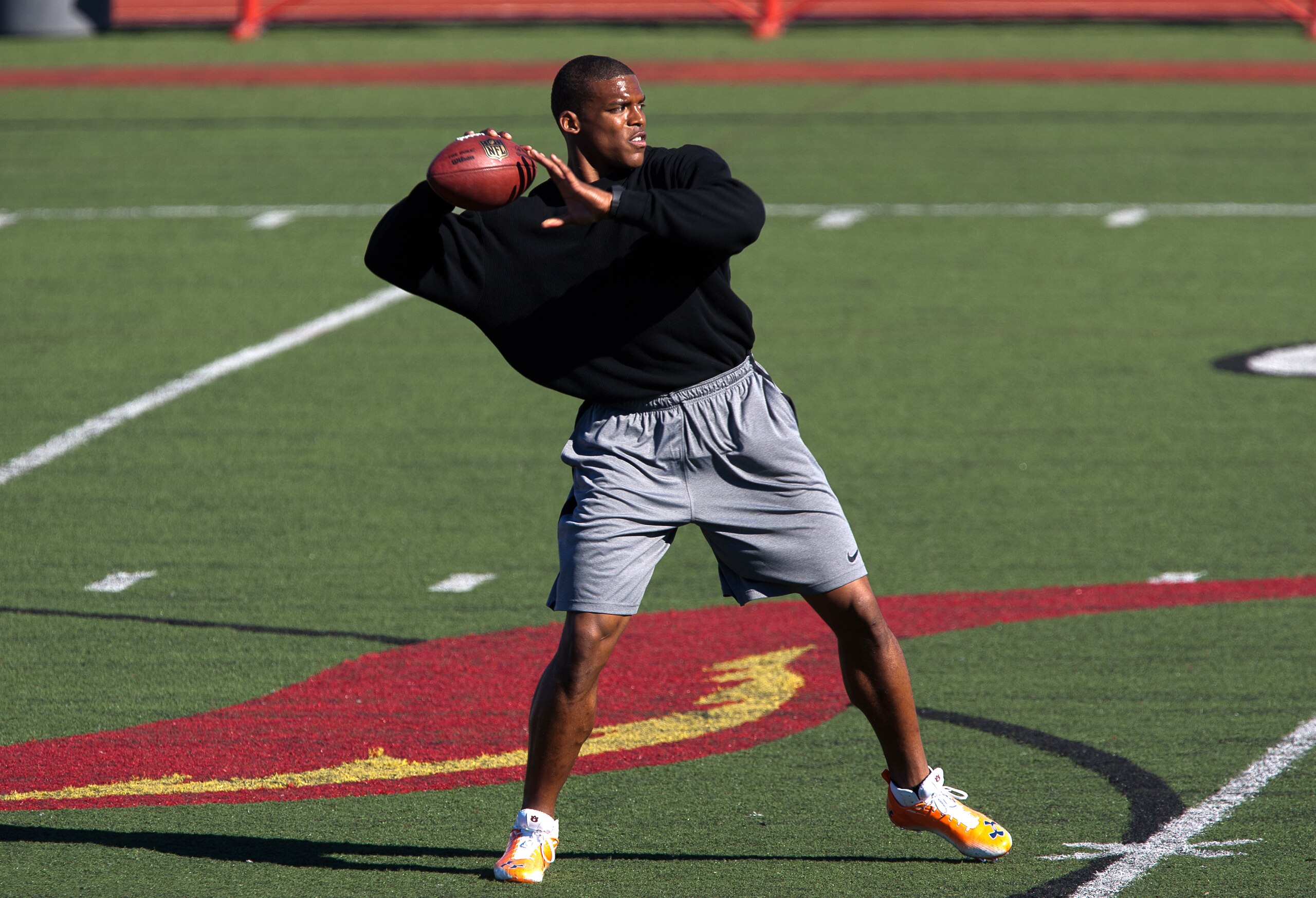 SAN DIEGO, CA - FEBRUARY 10: 2010 Heisman Trophy winning quarterback Cam Newton of Auburn throws the ball during his workout routine for the media at Cathedral High School's sports stadium on February 10, 2011 in San Diego, California. (Photo by Kent Horn