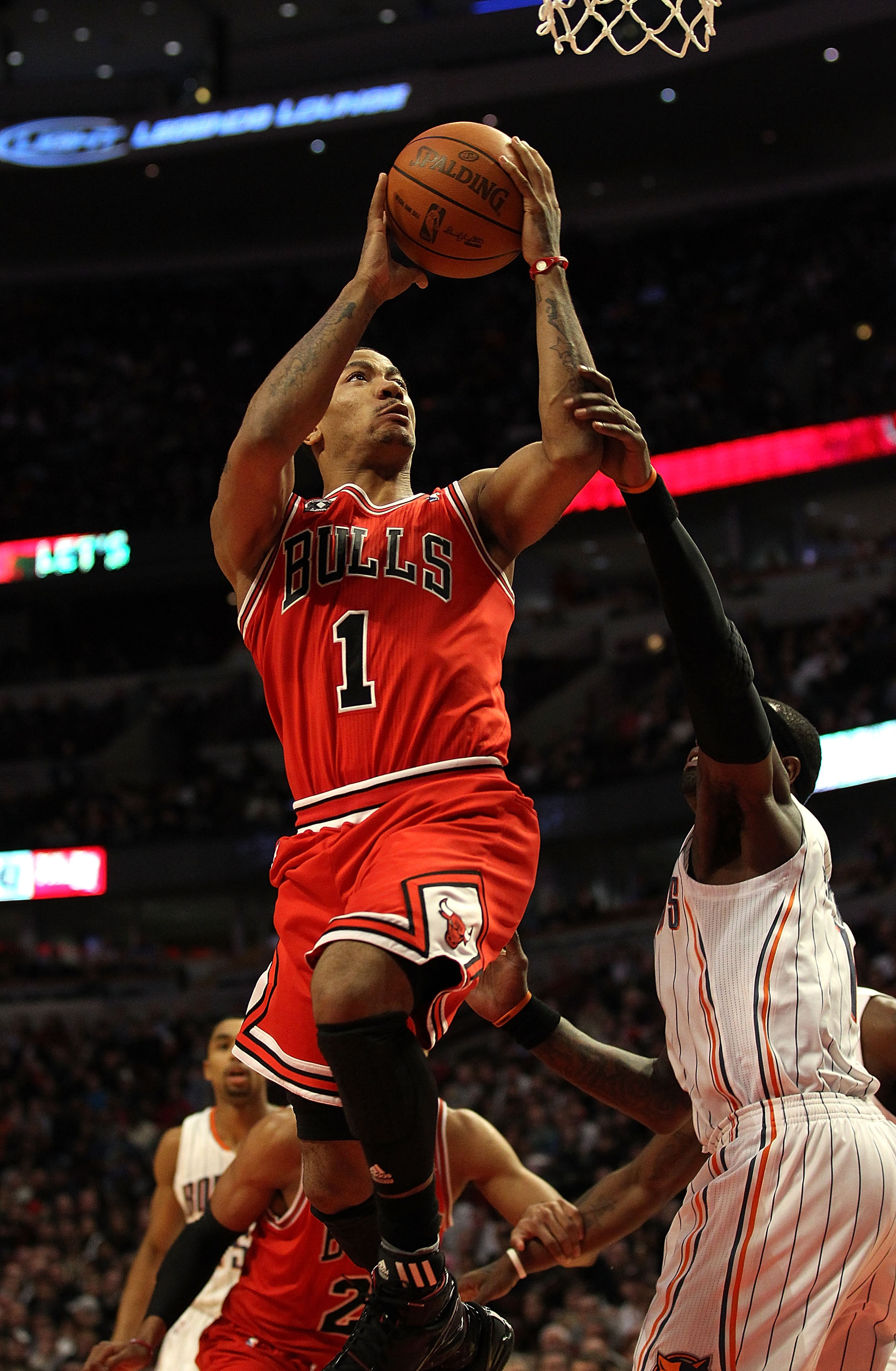 CHICAGO, IL - FEBRUARY 15: Derrick Rose #1 of the Chicago Bulls goes up to shoot past Stephen Jackson #1 of the Charlotte Bobcats at the United Center on February 15, 2011 in Chicago, Illinois. The Bulls defeated the Bobcats 106-94. NOTE TO USER: User exp