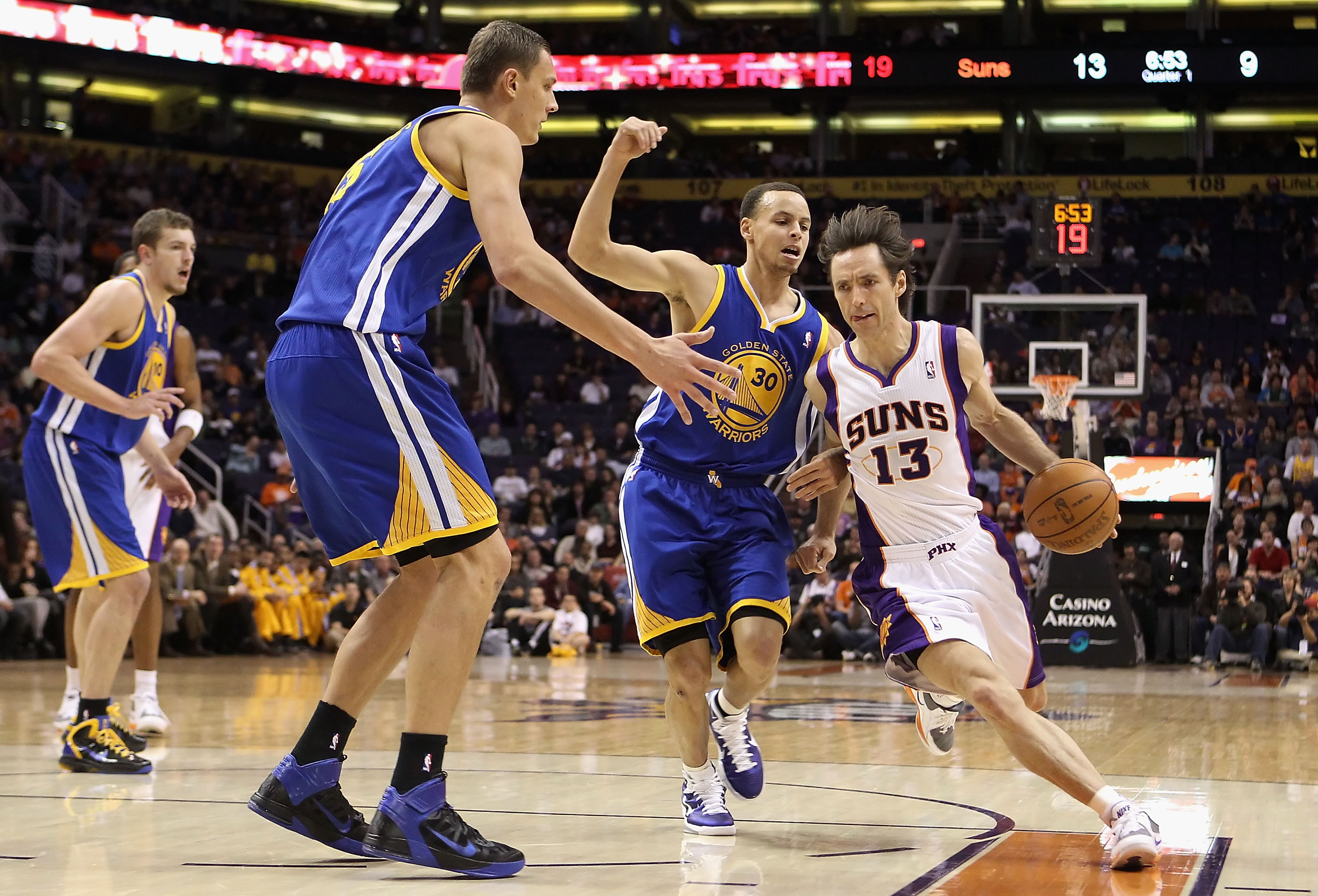 PHOENIX, AZ - FEBRUARY 10:  Steve Nash #13 of the Phoenix Suns drives the ball past Stephen Curry #30 of the Golden State Warriors during the NBA game at US Airways Center on February 10, 2011 in Phoenix, Arizona.  NOTE TO USER: User expressly acknowledge