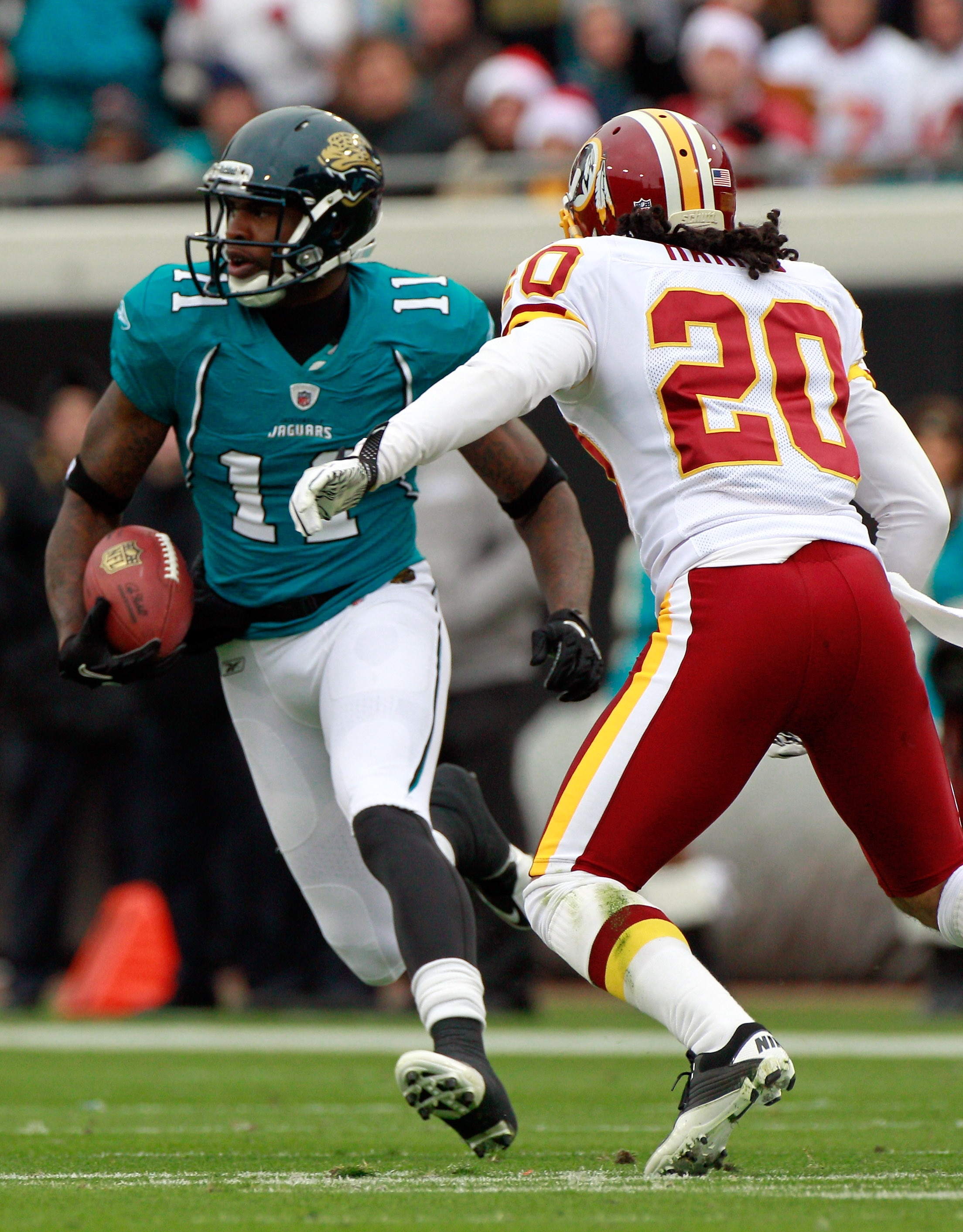JACKSONVILLE, FL - DECEMBER 26: Mike Sims-Walker #11 of the Jacksonville Jaguars attempts to run past Macho Harris #20 of the Washington Redskins during the game at EverBank Field on December 26, 2010 in Jacksonville, Florida.  (Photo by Sam Greenwood/Get