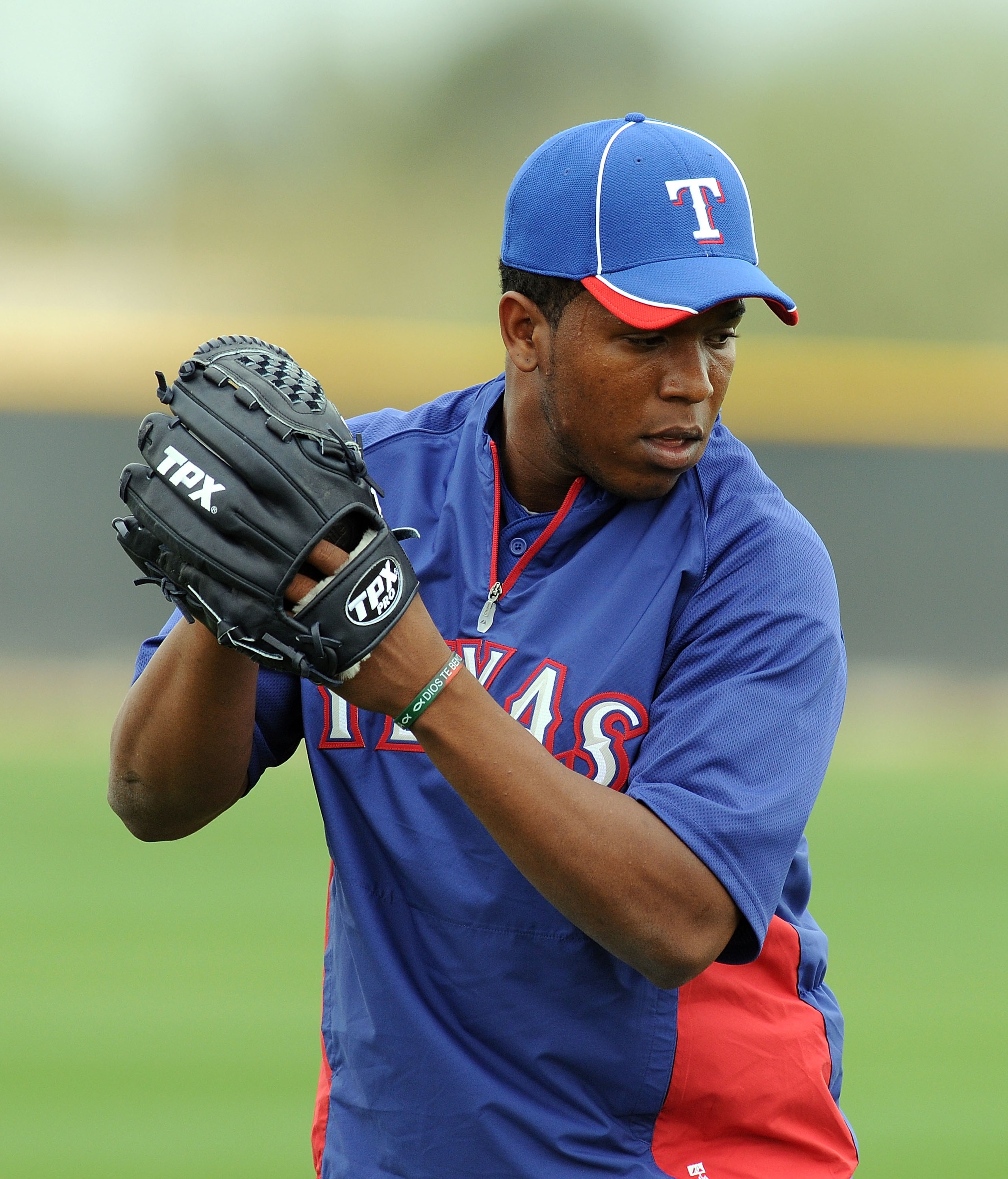 SURPRISE, AZ - FEBRUARY 18:  Neftali Feliz #30 of the Texas Rangers gets ready to deliver a pitch at Surprise Stadium on February 18, 2011 in Surprise, Arizona.  (Photo by Norm Hall/Getty Images)