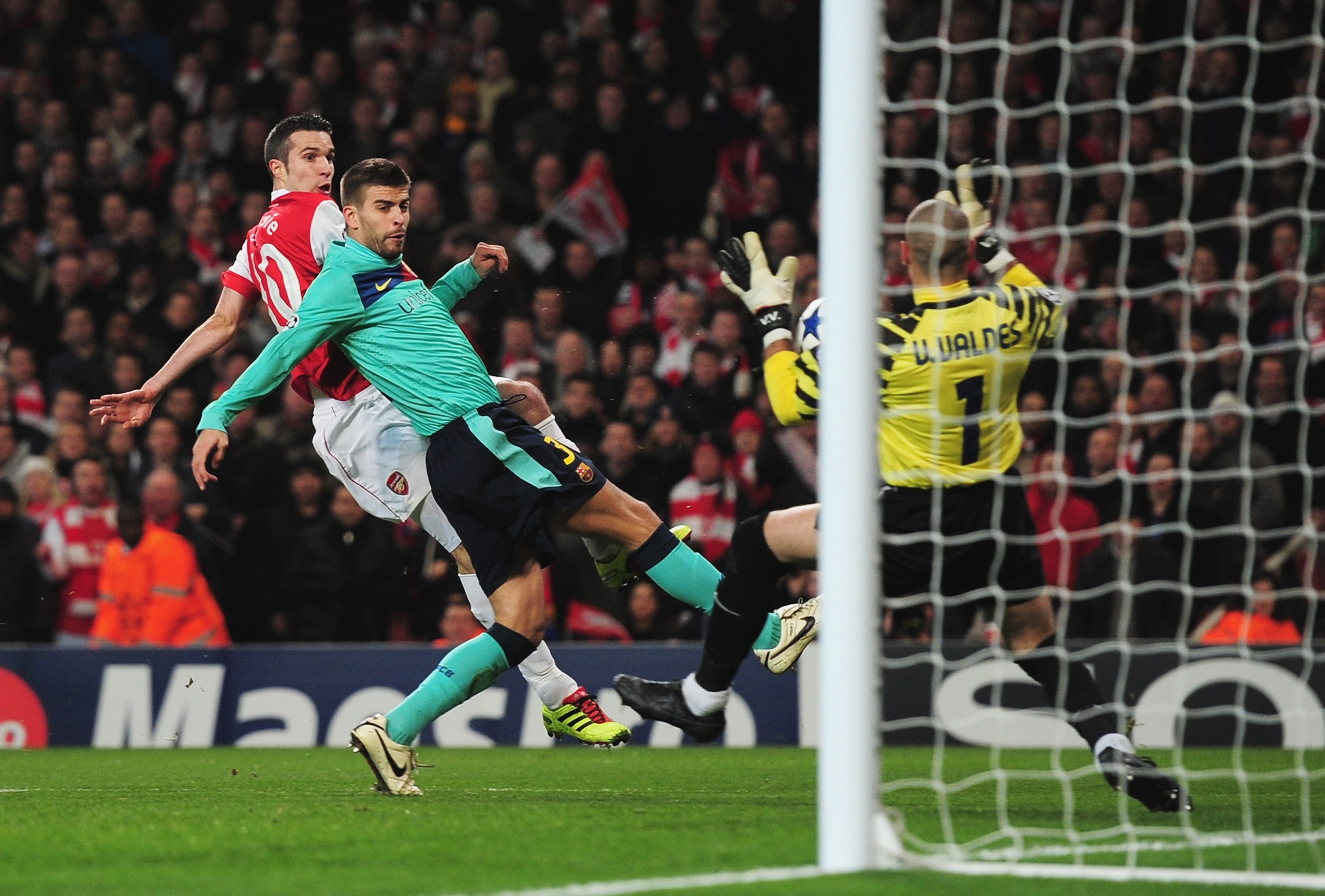 LONDON, ENGLAND - FEBRUARY 16: Robin van Persie of Arsenal has his shot saved by Victor Valdes of Barcelona during the UEFA Champions League round of 16 first leg match between Arsenal and Barcelona at the Emirates Stadium on February 16, 2011 in London, 