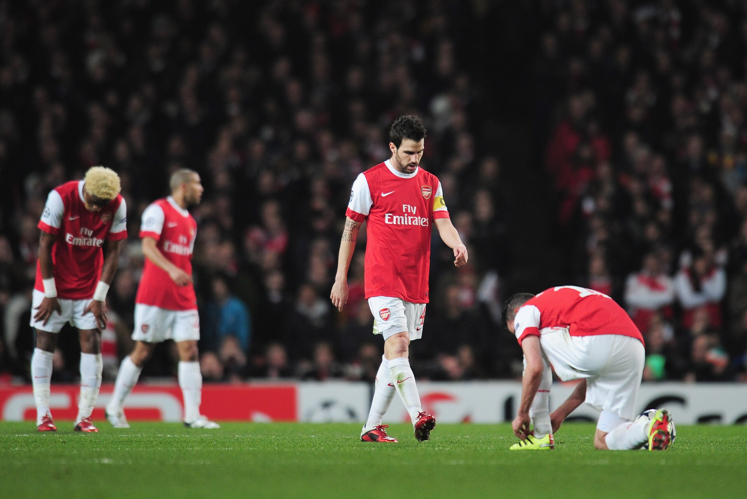 LONDON, ENGLAND - FEBRUARY 16:  Cesc Fabregas of Arsenal looks dejected after the Barcelona opening goal during the UEFA Champions League round of 16 first leg match between Arsenal and Barcelona at the Emirates Stadium on February 16, 2011 in London, Eng