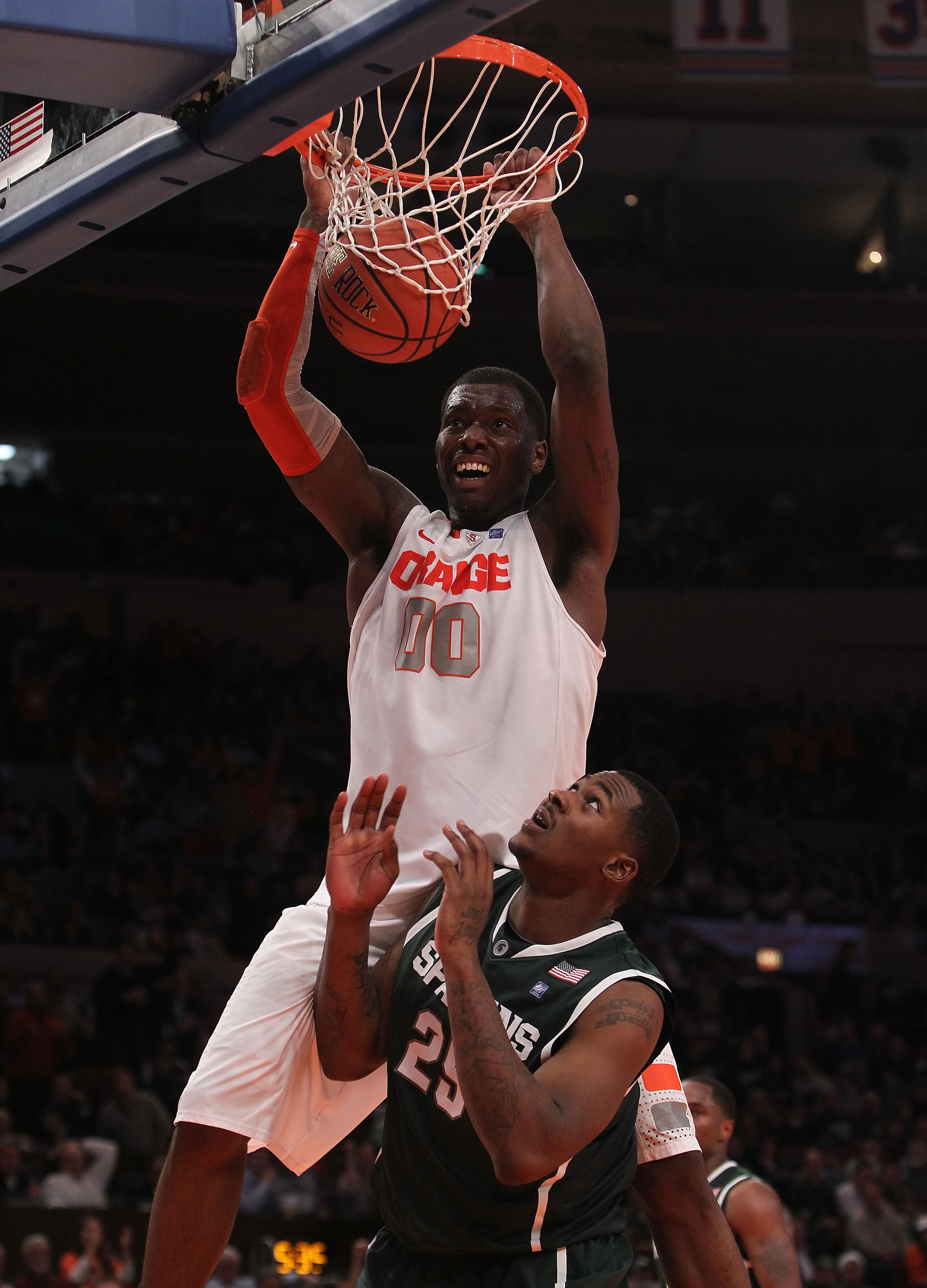 NEW YORK, NY - DECEMBER 07:  Rick Jackson #00 of Syracuse Orange dunks the ball on Derrick Nix #25 of the Michigan State Spartans during their game at the Jimmy V Classic at Madison Square Garden on December 7, 2010 in New York City.  (Photo by Nick Laham