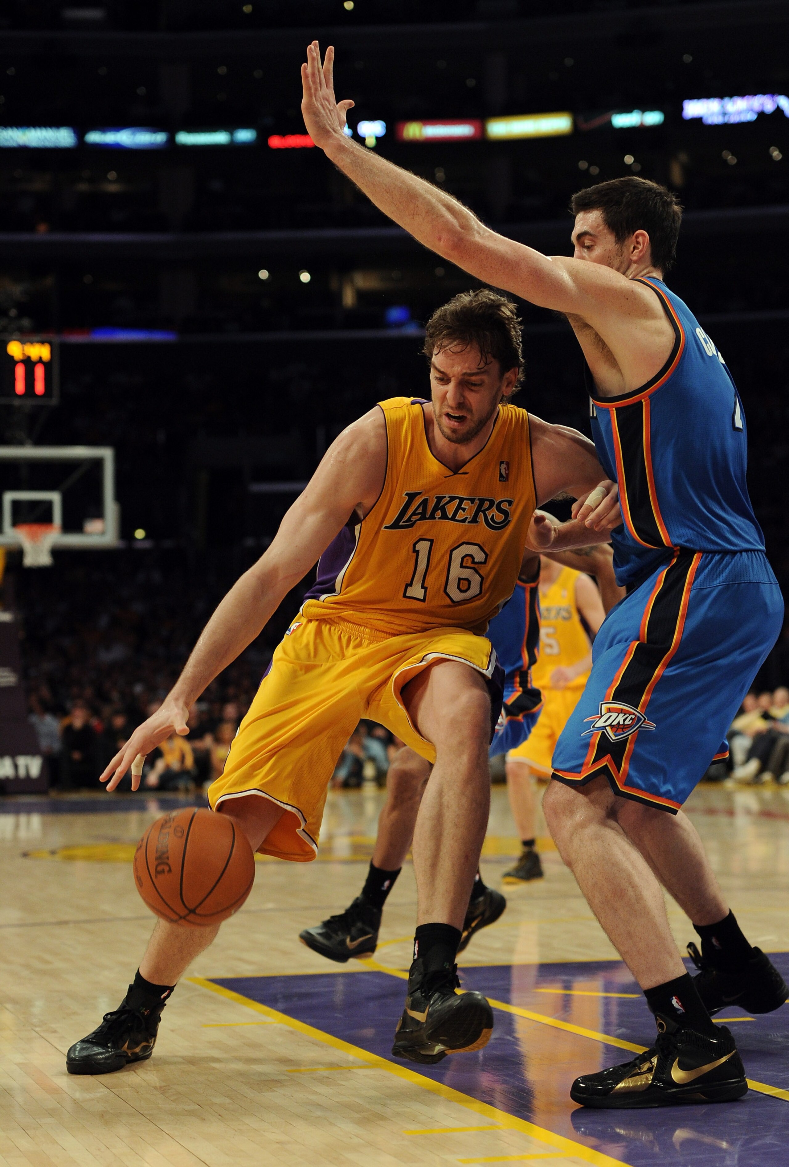 LOS ANGELES, CA - JANUARY 17:  Pau Gasol #16 of the Los Angeles Lakers dribbles around Nick Collison #4 of the Oklahoma City Thunder during a 101-94 Laker win at the Staples Center on January 17, 2011 in Los Angeles, California.  (Photo by Harry How/Getty