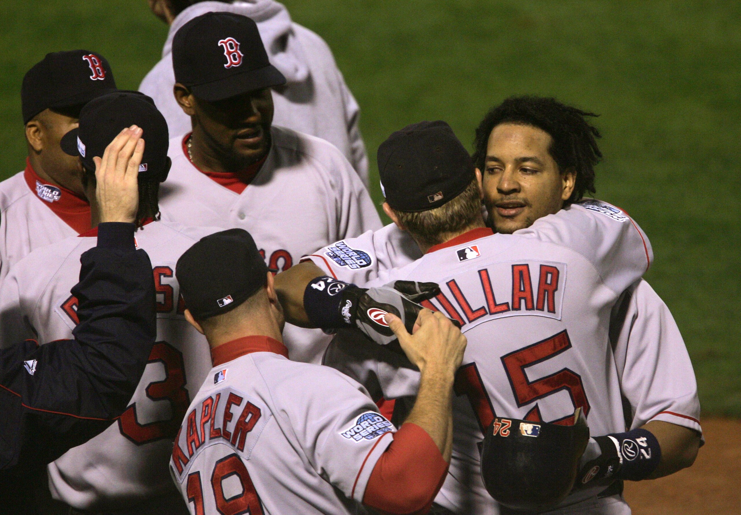 ST LOUIS - OCTOBER 26:  Manny Ramirez #24 of the Boston Red Sox hugs teammate Kevin Millar #15 after hitting a solo home run against the St. Louis Cardinals during game three of the World Series on October 26, 2004 at Busch Stadium in St. Louis, Missouri.