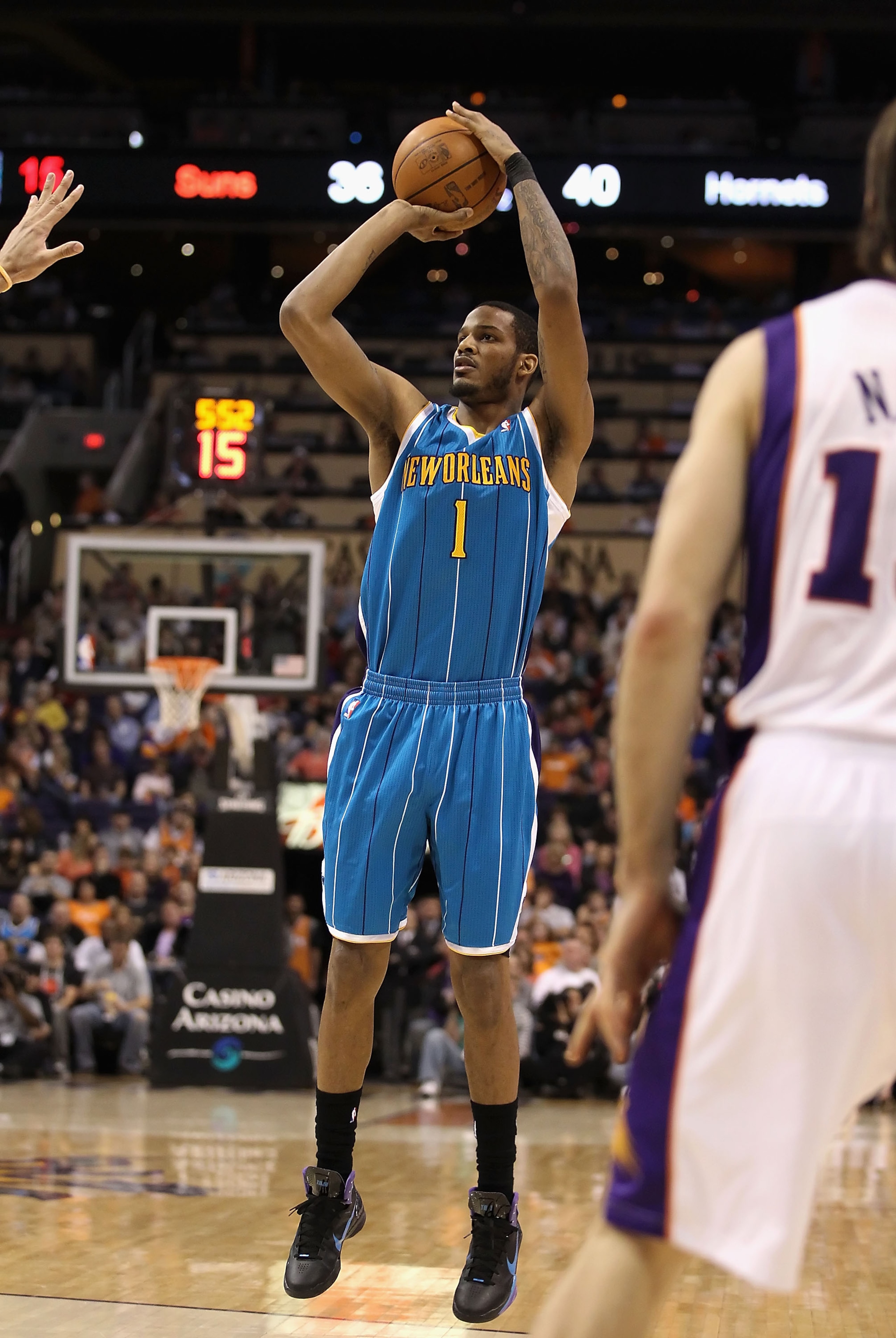PHOENIX, AZ - JANUARY 30:  Trevor Ariza #1 of the New Orleans Hornets puts up a shot during the NBA game against  the Phoenix Suns at US Airways Center on January 30, 2011 in Phoenix, Arizona.  The Suns defeated the Hornets 104-102. NOTE TO USER: User exp