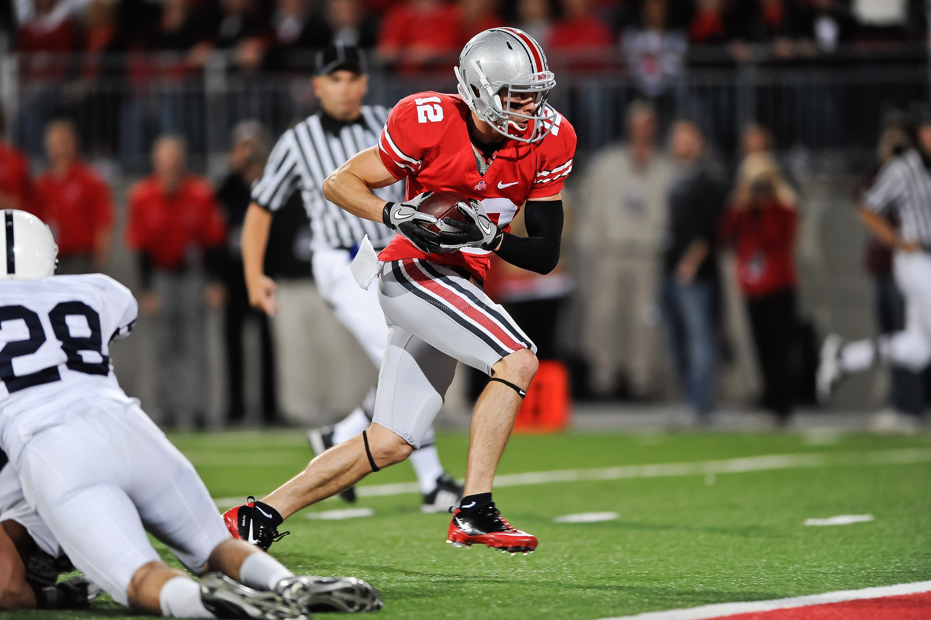 COLUMBUS, OH - NOVEMBER 13:  Dane Sanzenbacher #12 of the Ohio State Buckeyes scores a touchdown against the Penn State Nittany Lions at Ohio Stadium on November 13, 2010 in Columbus, Ohio.  (Photo by Jamie Sabau/Getty Images)