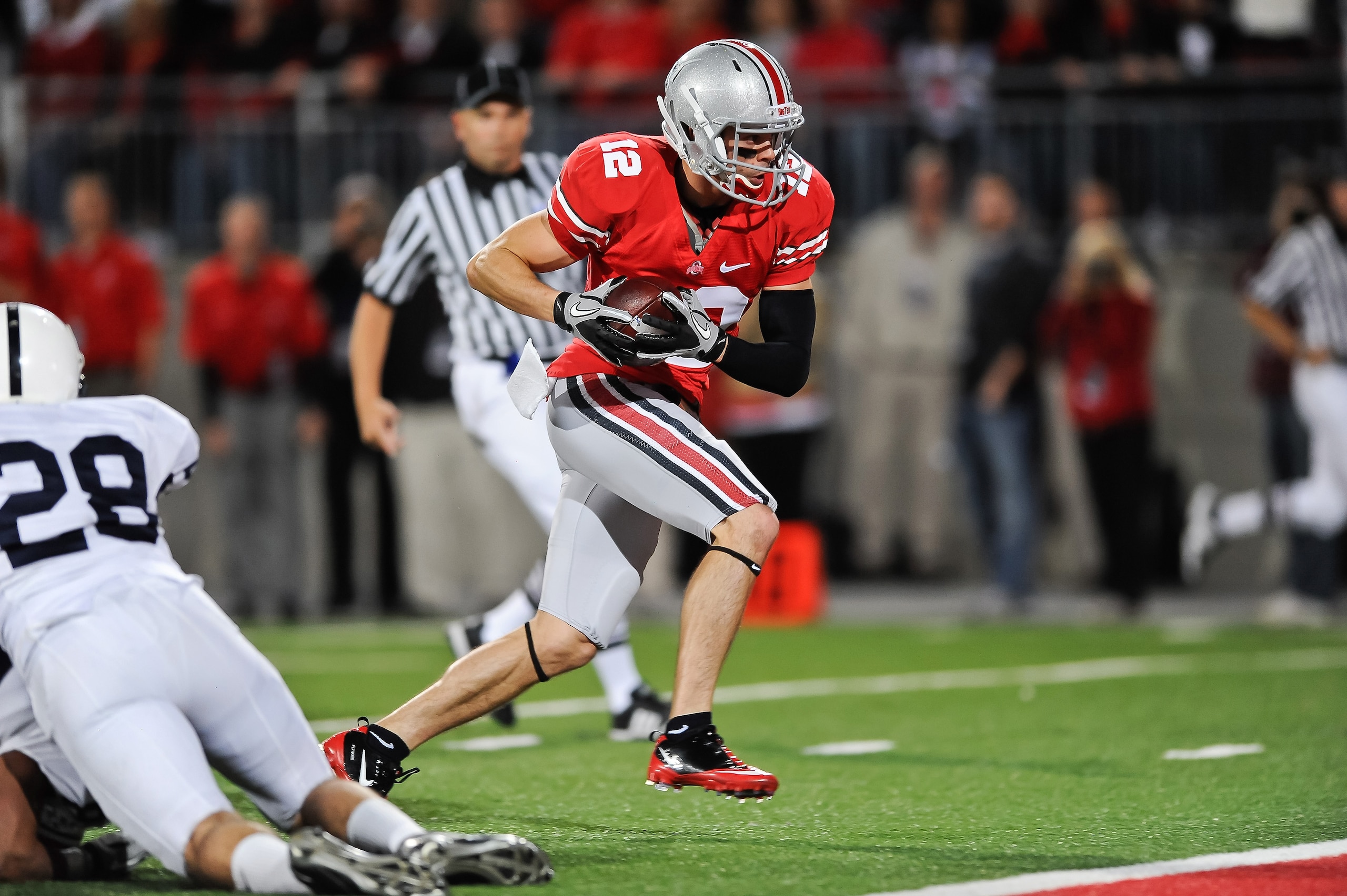COLUMBUS, OH - NOVEMBER 13:  Dane Sanzenbacher #12 of the Ohio State Buckeyes scores a touchdown against the Penn State Nittany Lions at Ohio Stadium on November 13, 2010 in Columbus, Ohio.  (Photo by Jamie Sabau/Getty Images)