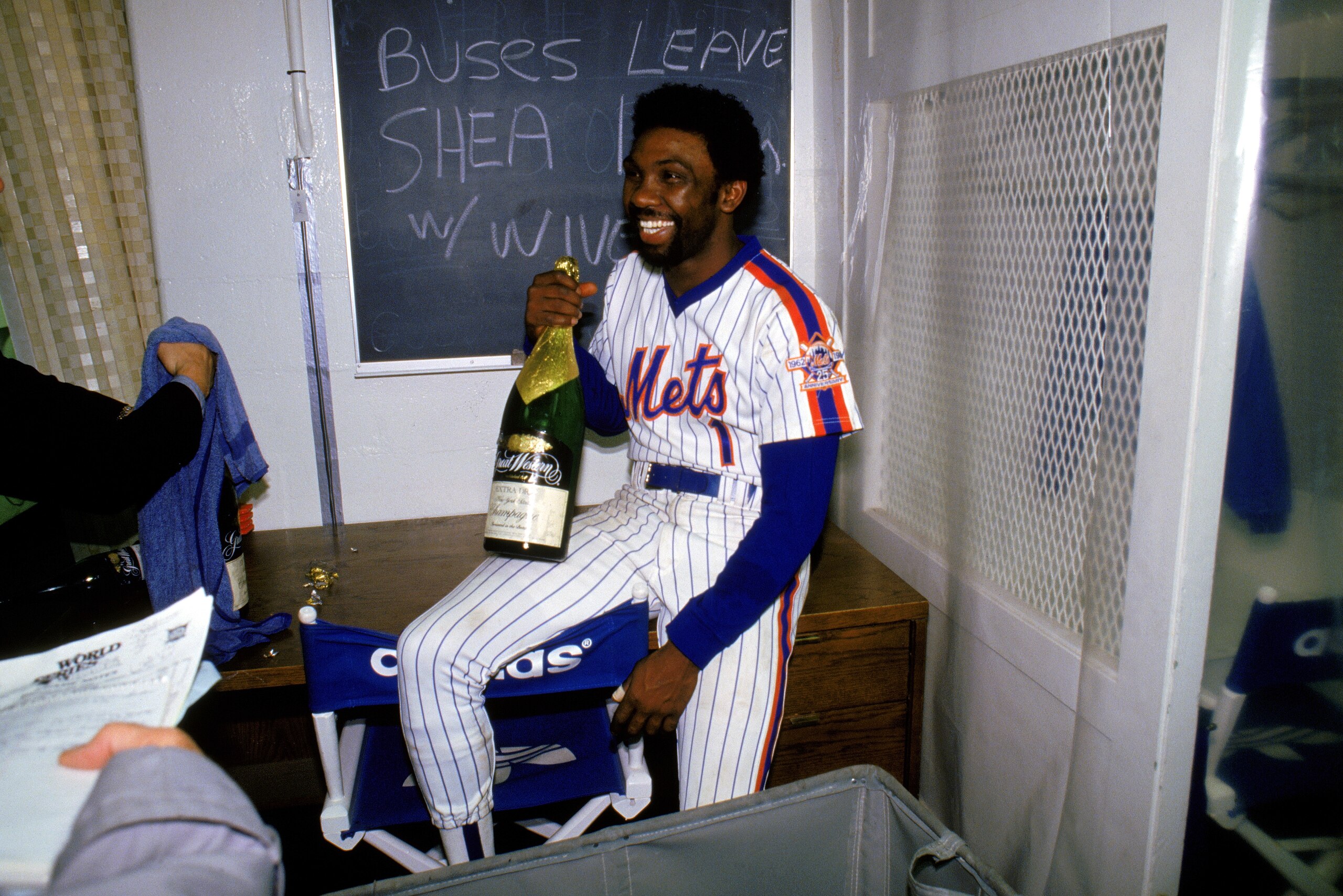 FLUSHING, NY - OCTOBER 27:  Outfielder Mookie Wilson #1 of the New York Mets celebrates with a bottle of champagne after winning game 7 of the 1986 World Series against the Boston Red Sox at Shea Stadium on October 27, 1986 in Flushing, New York. The Mets