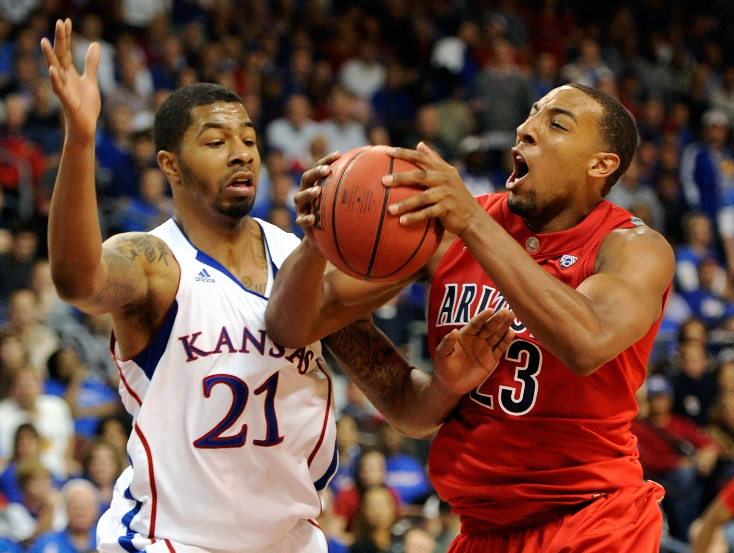 LAS VEGAS - NOVEMBER 27:  Markieff Morris #21 of the Kansas Jayhawks fouls Derrick Williams #23 of the Arizona Wildcats during the championship game of the Las Vegas Invitational at The Orleans Arena November 27, 2010 in Las Vegas, Nevada. Kansas won 87-7