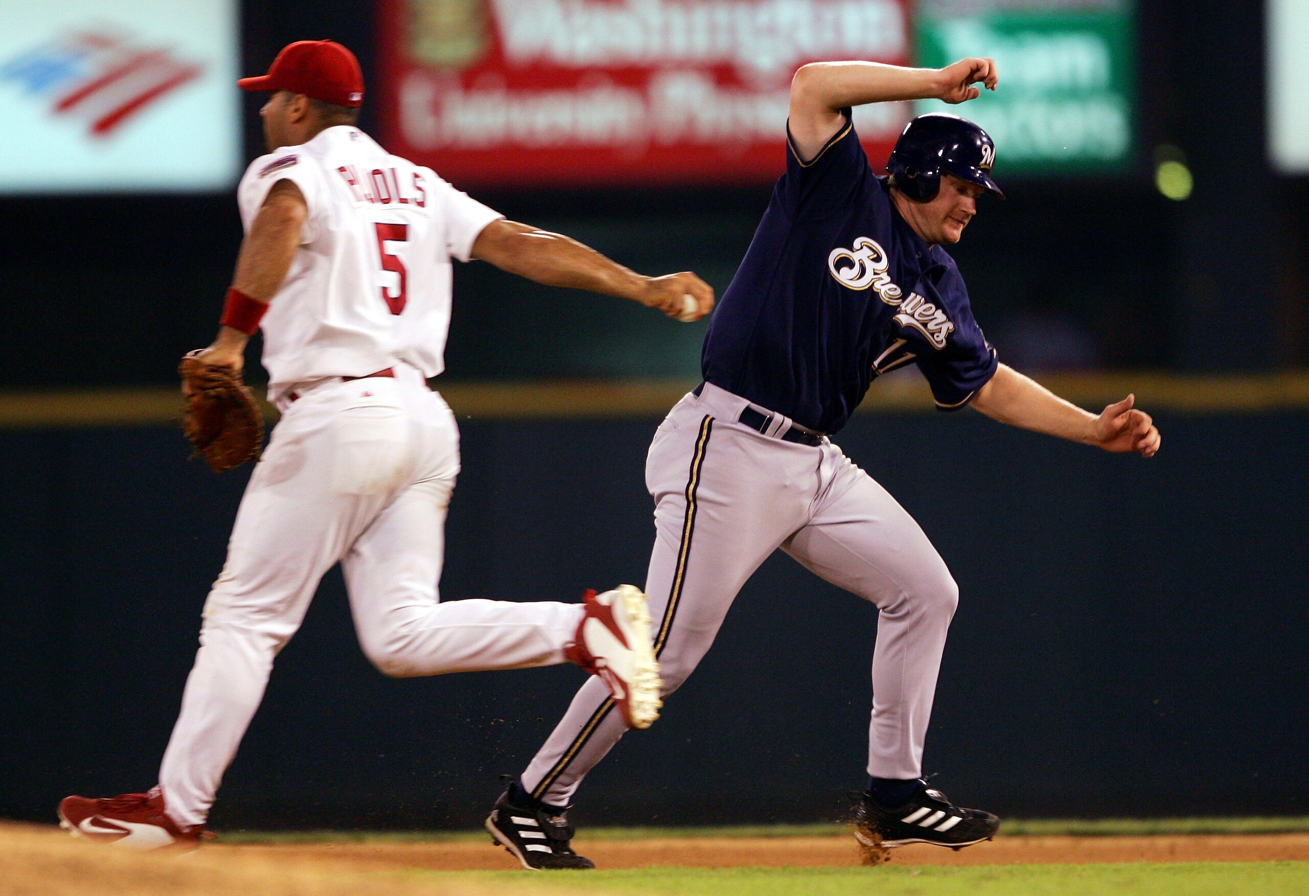 ST. LOUIS - JULY 19:  Lyle Overbay #11 of the Milwaukee Brewers is tagged out by Albert Pujols #5 of the St. Louis Cardinals on July 19, 2005 at Busch Stadium in St. Louis, Missouri.  (Photo by Elsa/Getty Images)