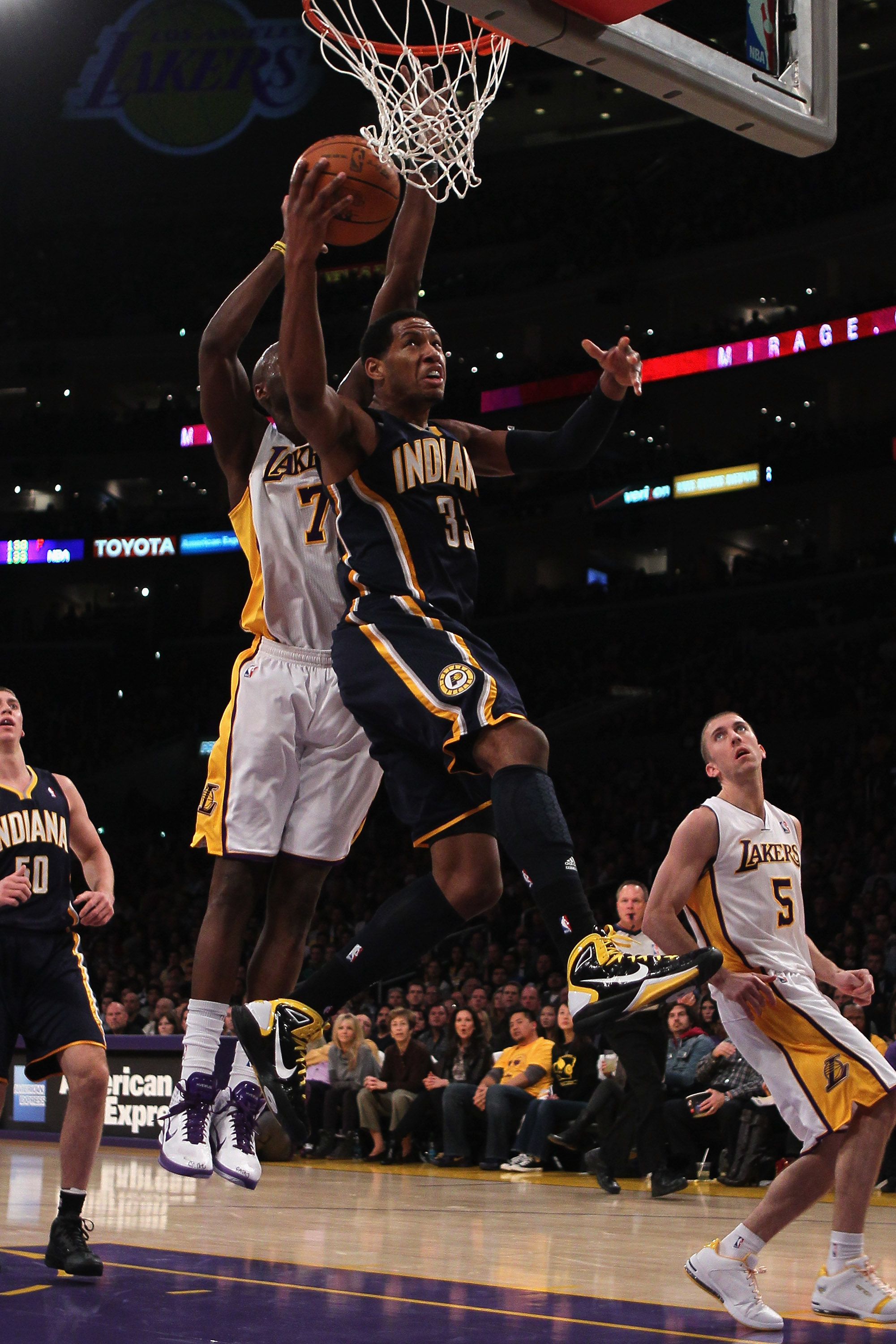 LOS ANGELES, CA - NOVEMBER 28:  Danny Granger #33 of the Indiana Pacers drives to the basket past  Lamar Odom #7 of the Los Angeles Lakers during the fourth quarter at Staples Center on November 28, 2010 in Los Angeles, California. The Pacers defeated the