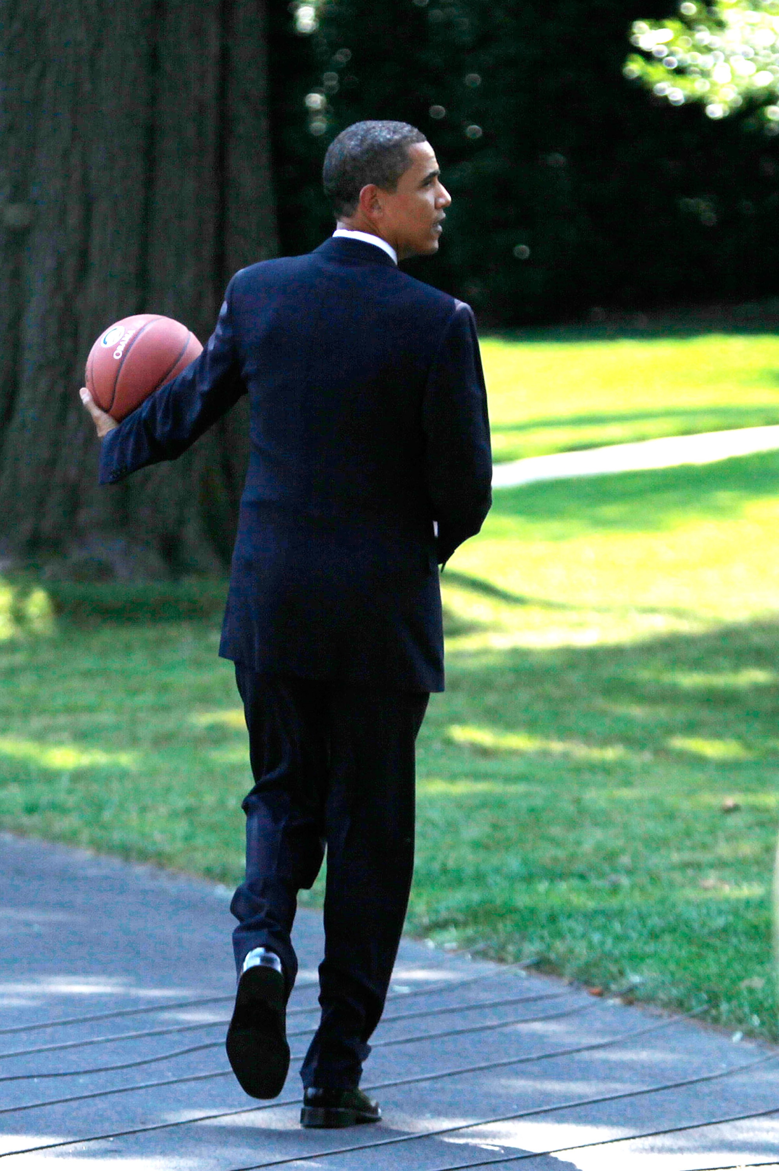 WASHINGTON - JULY 27:  U.S. President Barack Obama holds a basketball as he walks toward the Oval Office after he hosted Detroit Shock at the South Portico of the White House July 27, 2009 in Washington, DC. The President hosted the Detroit Shock in honor