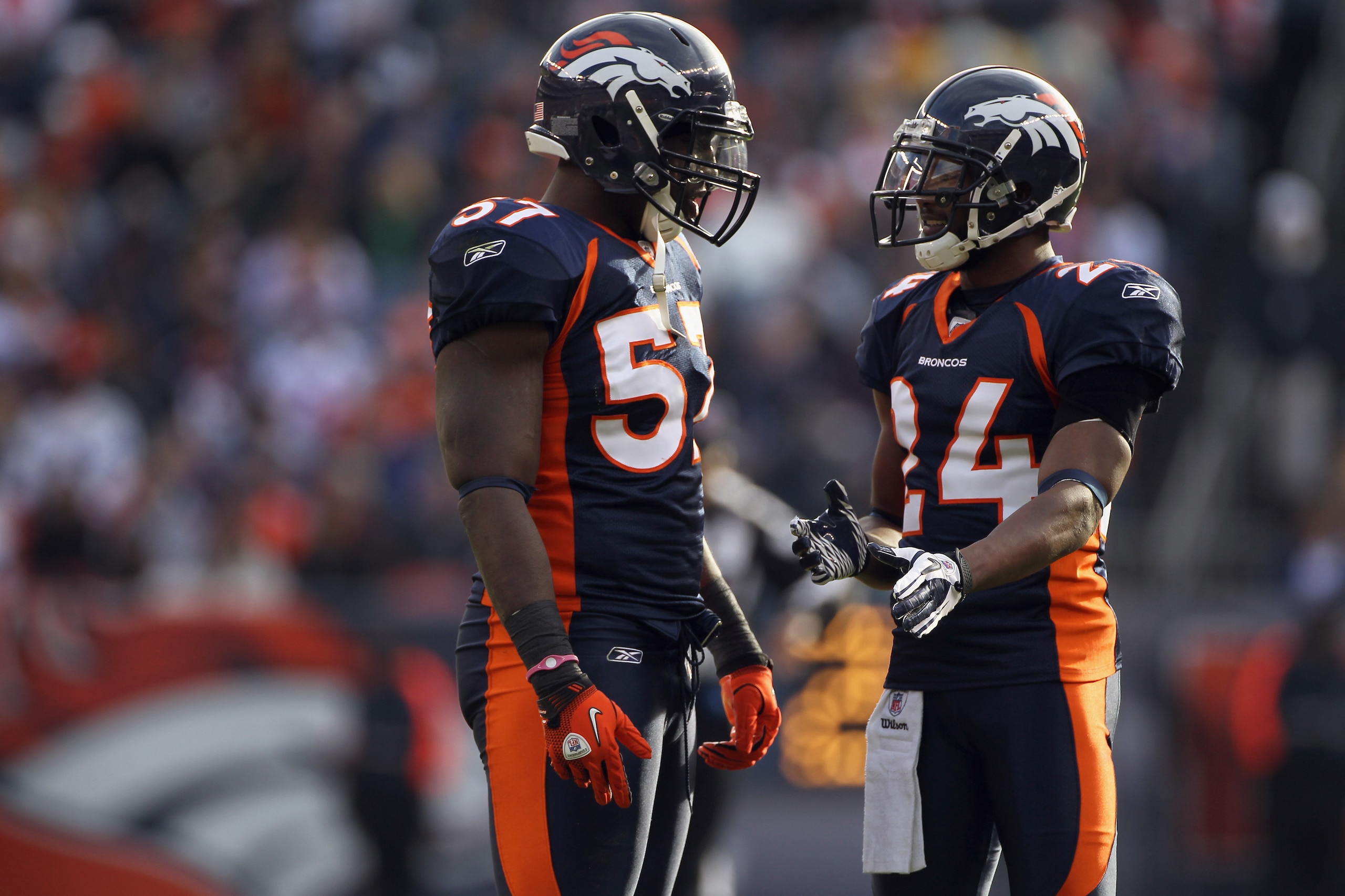 DENVER - DECEMBER 26:  Linebacker Mario Haggen #57 and cornerback Champ Bailey #24 of the Denver Broncos talk during a break in the action against the Houston Texans at INVESCO Field at Mile High on December 26, 2010 in Denver, Colorado. The Broncos defea