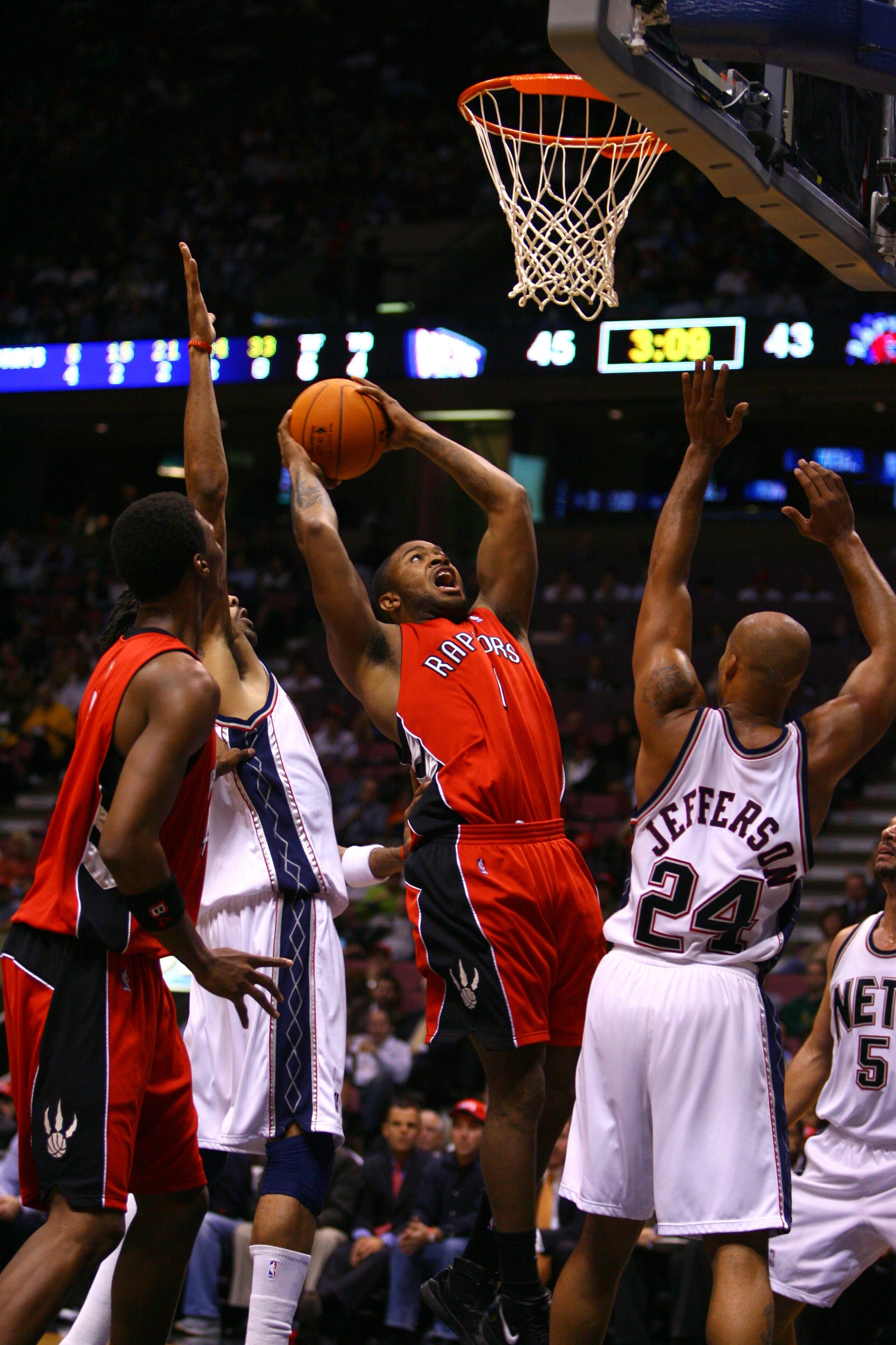 EAST RUTHERFORD, NJ - NOVEMBER 1:  P.J. Tucker #1 of the Toronto Raptors shoots over Richard Jefferson #24 of the New Jersey Nets during the game at the Continental Airlines Arena on November 1, 2006 in East Rutherford, New Jersey. The Nets won 102-92. NO