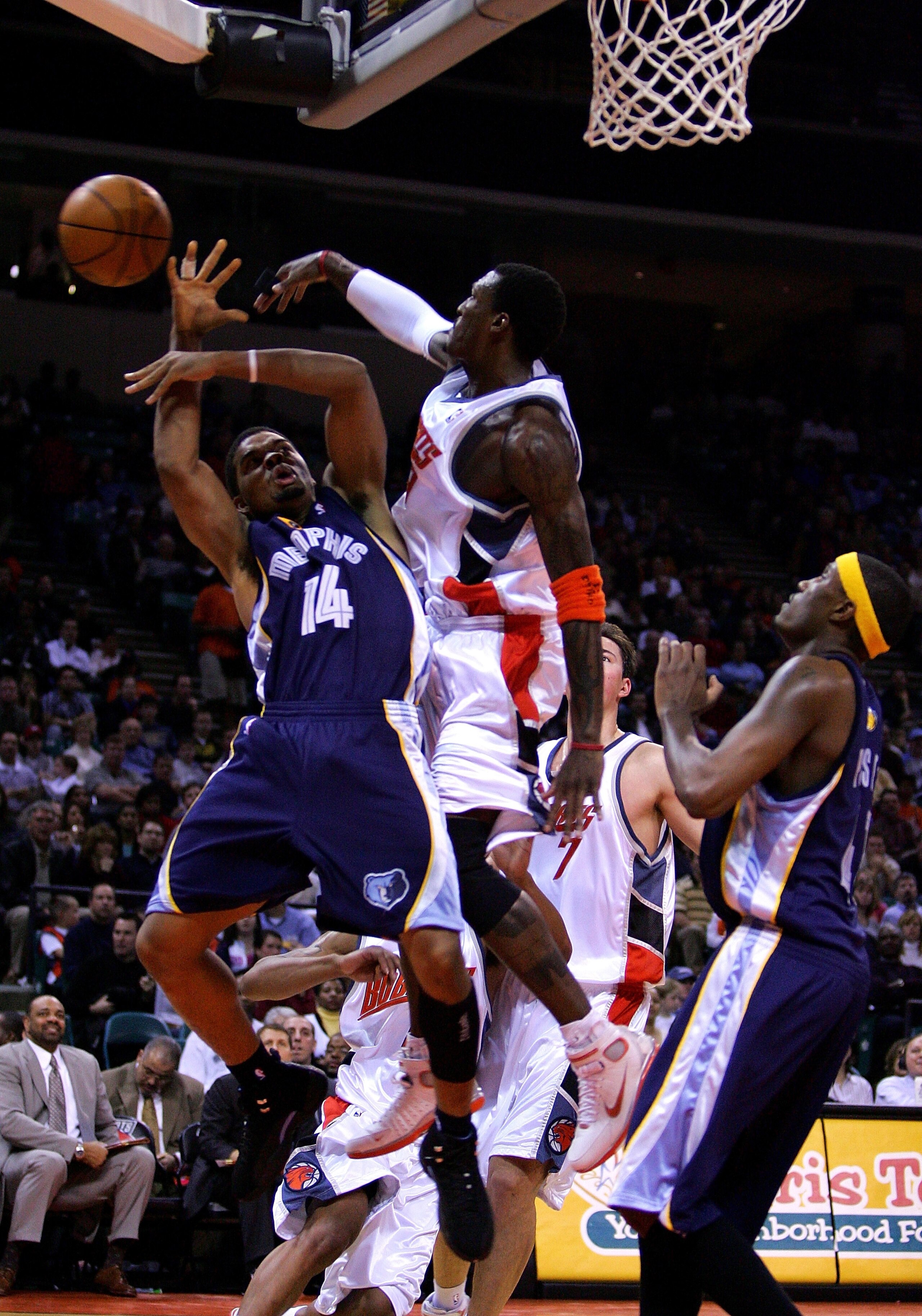 CHARLOTTE, NC - JANUARY 14:  Andre Emmett #14 of the Memphis Grizzlies is fouled by Gerald Wallace #3 of the Charlotte Bobcats on January 14, 2005 at the Charlotte Coliseum in Charlotte, North Carolina.  NOTE TO USER: User expressly acknowledges and agree