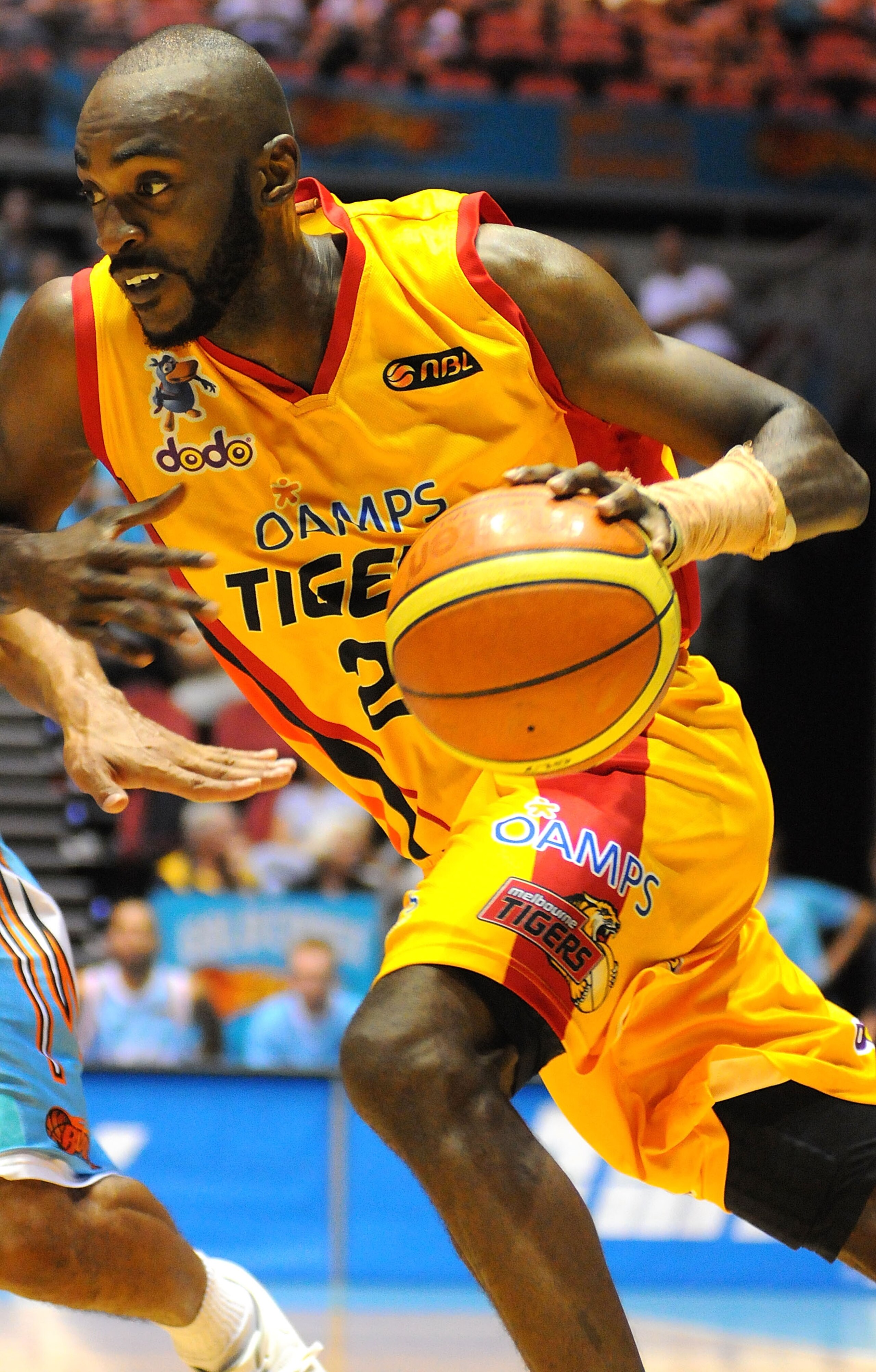 GOLD COAST, AUSTRALIA - JANUARY 30:  Julius Hodge of the Melbourne Tigers dribbles the ball around Blaze defenders during the round 18 NBL match between the Gold Coast Blaze and the Melbourne Tigers at Gold Coast Convention and Exhibition Centre on Januar