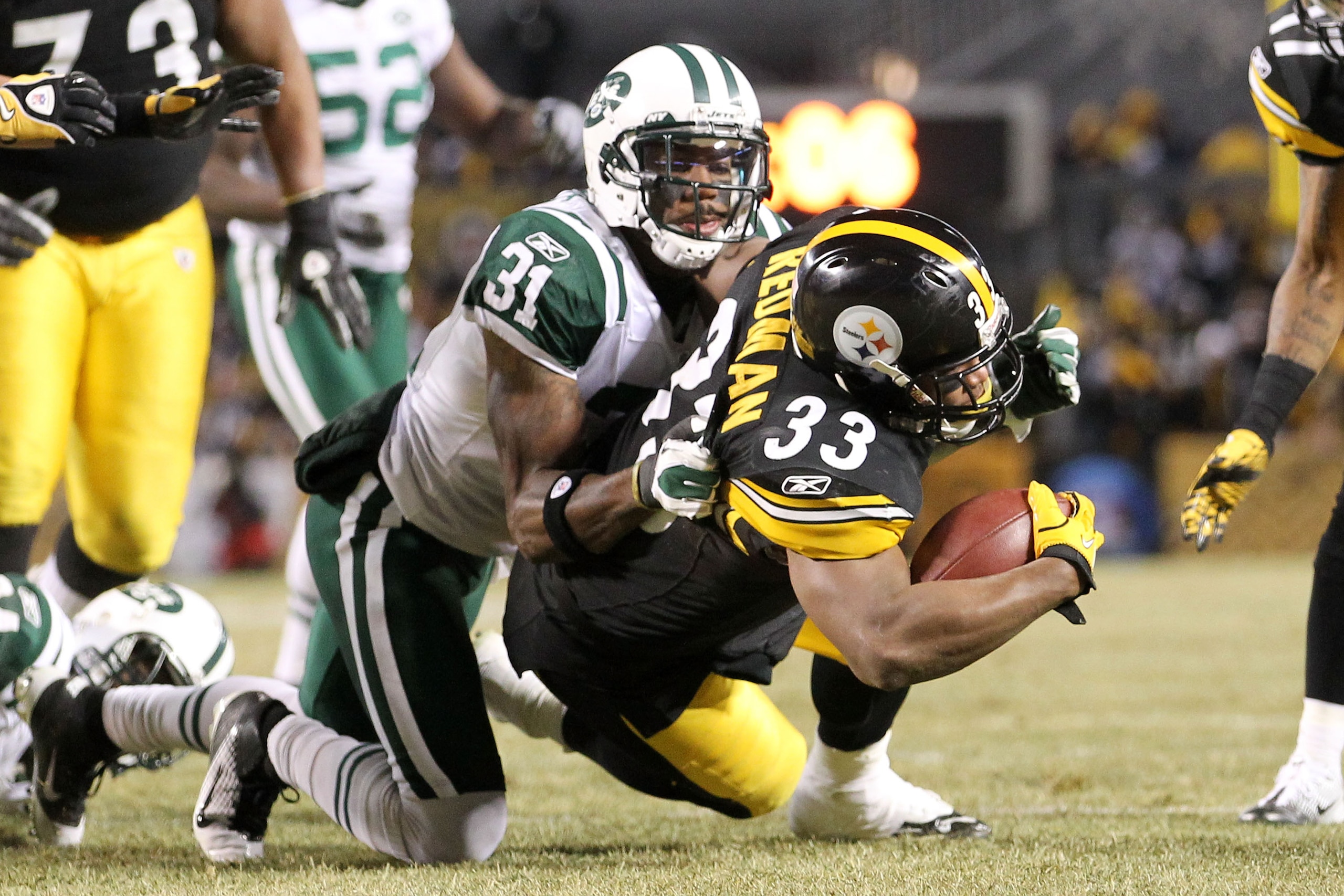 PITTSBURGH, PA - JANUARY 23: Isaac Redman #33 of the Pittsburgh Steelers is tackled by Antonio Cromartie #31 of the New York Jets during the 2011 AFC Championship game at Heinz Field on January 23, 2011 in Pittsburgh, Pennsylvania. (Photo by Ronald Mart PITTSBURGH, PA - JANUARY 23: Isaac Redman #33 of the Pittsburgh Steelers is tackled by Antonio Cromartie #31 of the New York Jets during the 2011 AFC Championship game at Heinz Field on January 23, 2011 in Pittsburgh, Pennsylvania. (Photo by Ronald Mart