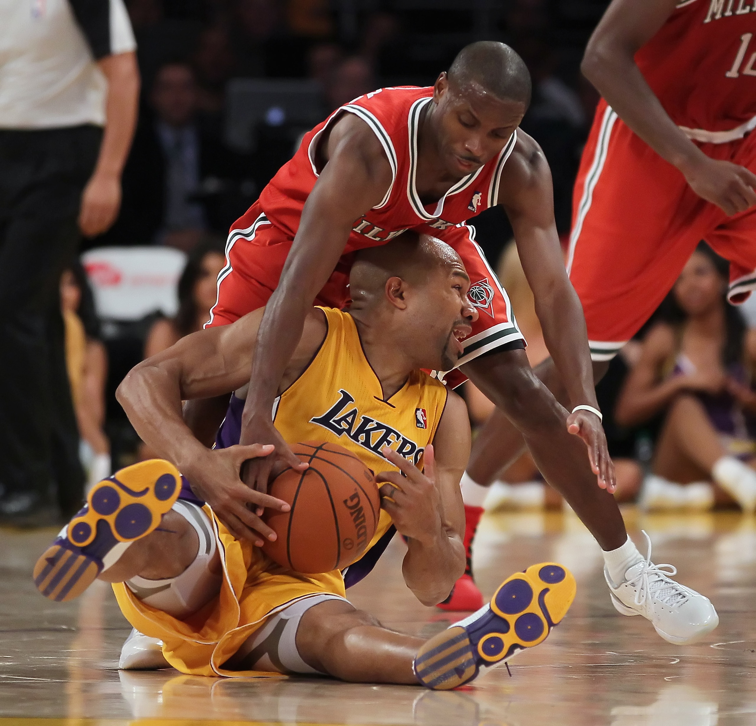 LOS ANGELES, CA - DECEMBER 21:  Earl Boykins #11 of the Milwaukee Bucks ties up Derek Fisher #2 of the Los Angeles Lakers during the second half at Staples Center on December 21, 2010 in Los Angeles, California. The Bucks defeated the Lakers 98-79. NOTE T
