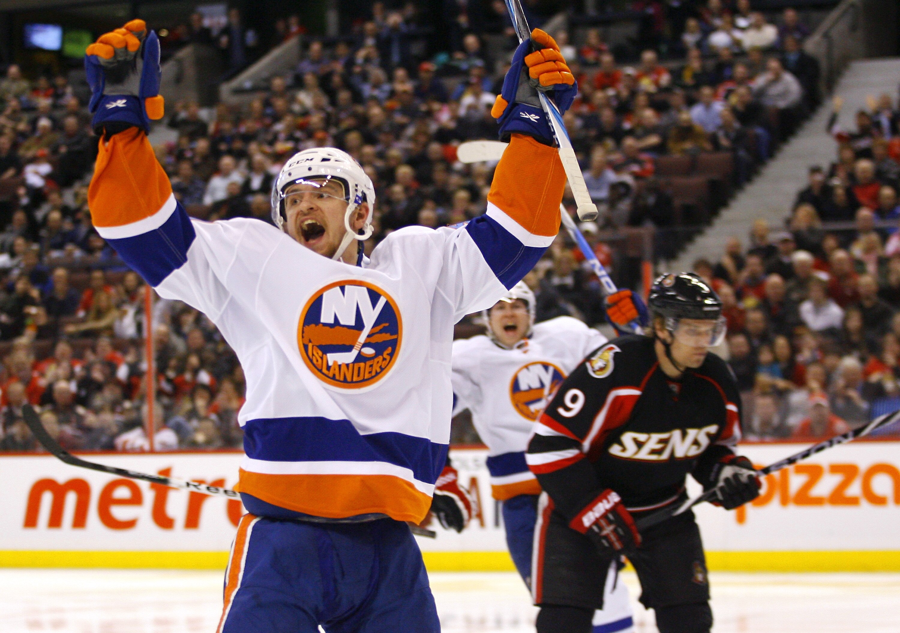 OTTAWA, ON - FEBRUARY 15:  Michael Grabner #40 of the New York Islanders celebrates a short-handed goal while Milan Michalek #9 of the Ottawa Senators reacts dejectedly in a game at Scotiabank Place on February 15, 2011 in Ottawa, Ontario, Canada.  The Ne