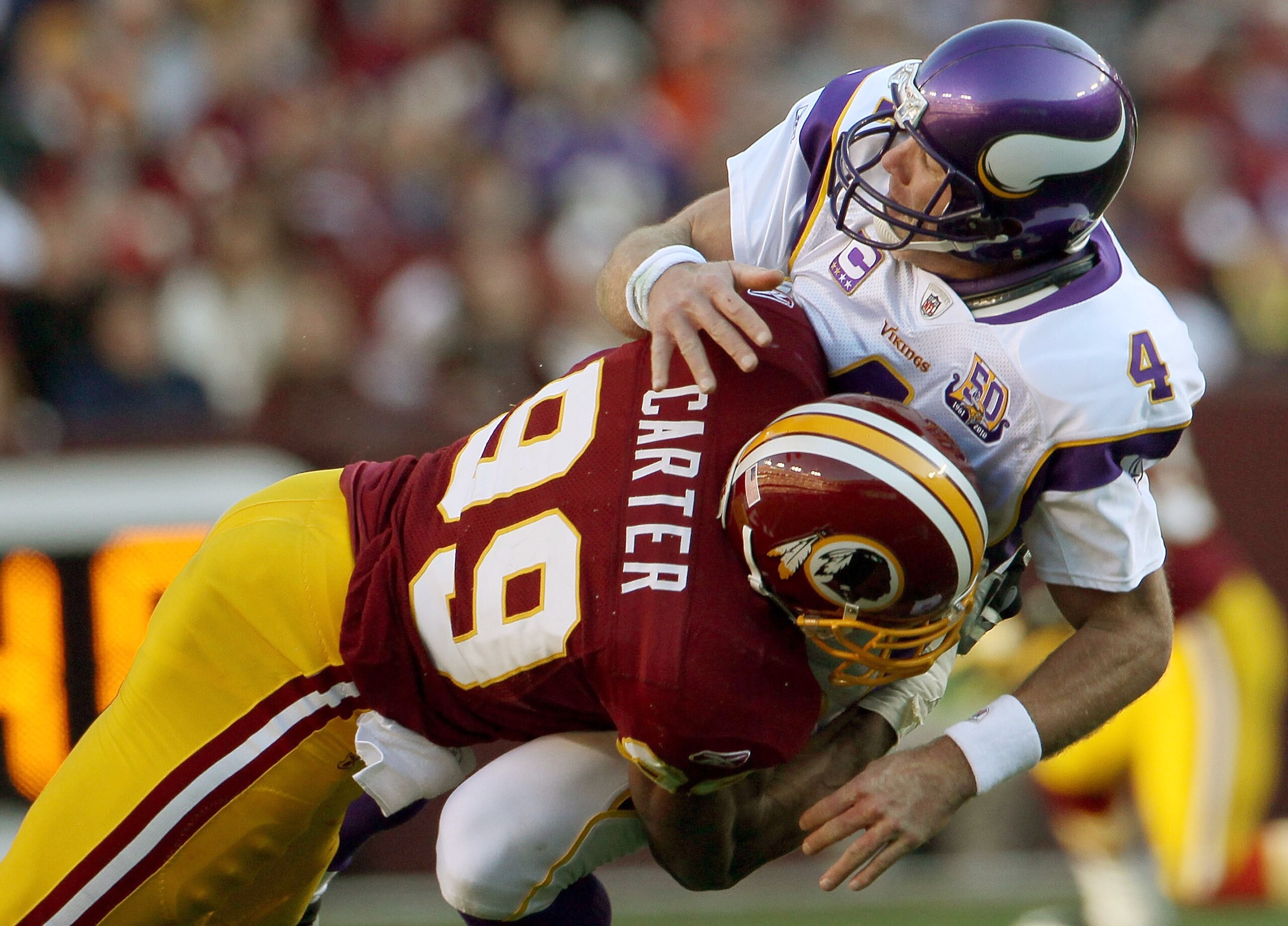 LANDOVER, MD - NOVEMBER 28: Brett Favre #4 of the Minnesota Vikings is hit by Washington Redskins linebacker Andre Carter #99 at FedExField November 28, 2010 in Landover, Maryland. The Vikings won the game 17-13. (Photo by Win McNamee/Getty Images) LANDOVER, MD - NOVEMBER 28: Brett Favre #4 of the Minnesota Vikings is hit by Washington Redskins linebacker Andre Carter #99 at FedExField November 28, 2010 in Landover, Maryland. The Vikings won the game 17-13. (Photo by Win McNamee/Getty Images)