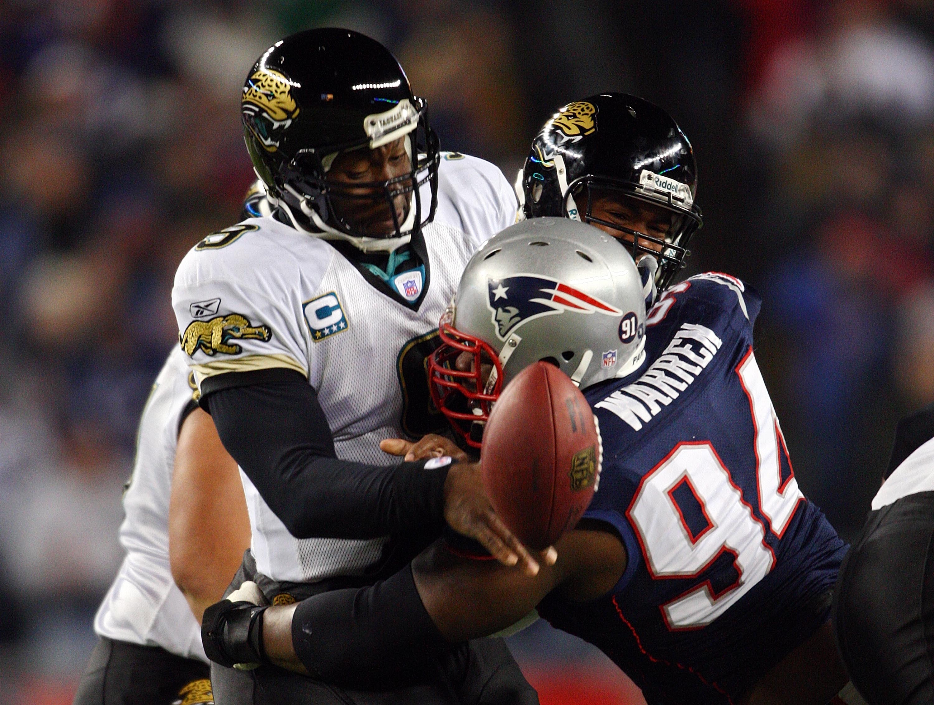 FOXBOROUGH, MA - JANUARY 12:  Ty Warren #94 of the New England Patriots causes David Garrard #9 of the Jacksonville Jaguars to fumble during the AFC Divisional playoff game at Gillette Stadium game on January 12, 2008 in Foxboro, Massachusetts.  (Photo by