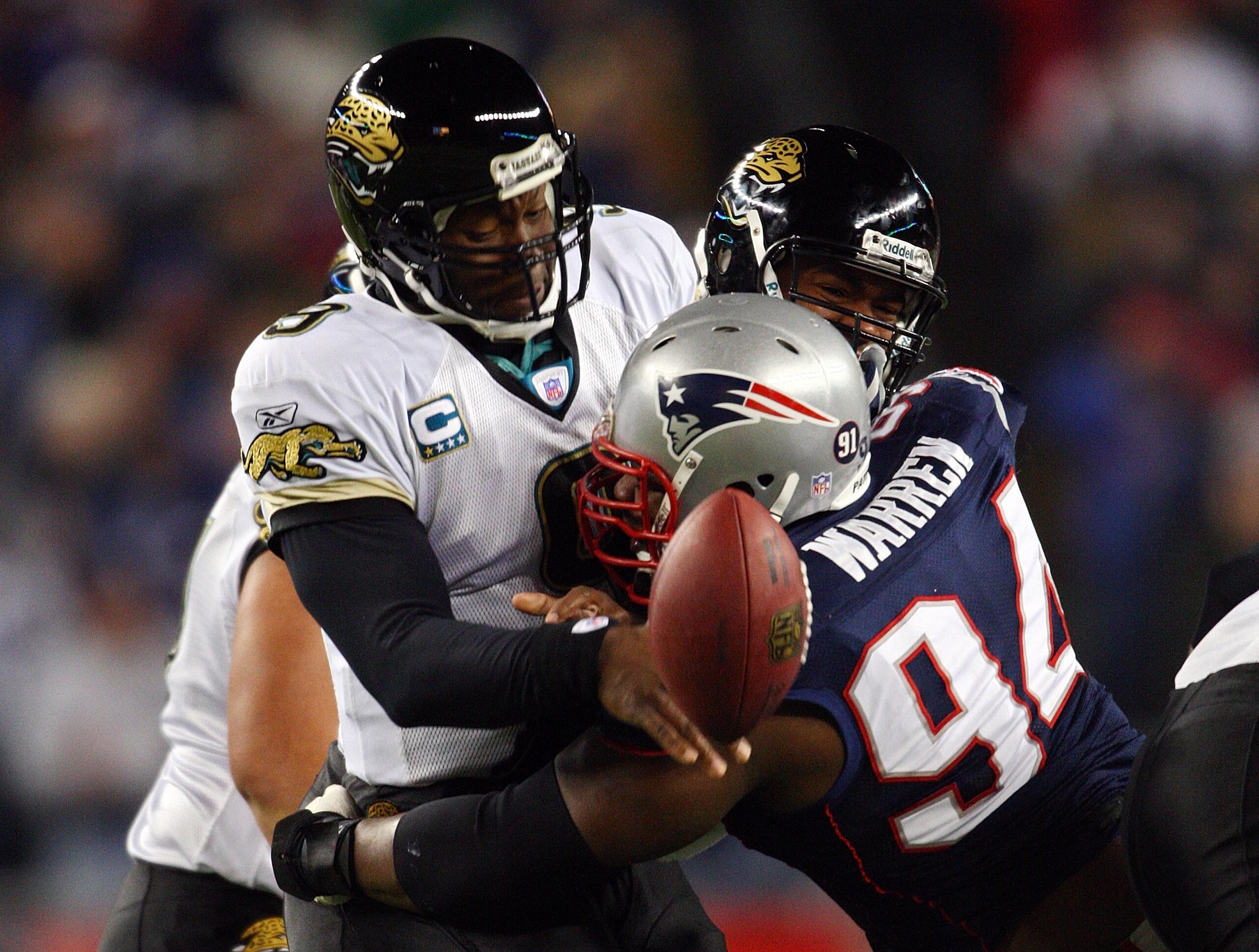 FOXBOROUGH, MA - JANUARY 12: Ty Warren #94 of the New England Patriots causes David Garrard #9 of the Jacksonville Jaguars to fumble during the AFC Divisional playoff game at Gillette Stadium game on January 12, 2008 in Foxboro, Massachusetts. (Photo by FOXBOROUGH, MA - JANUARY 12: Ty Warren #94 of the New England Patriots causes David Garrard #9 of the Jacksonville Jaguars to fumble during the AFC Divisional playoff game at Gillette Stadium game on January 12, 2008 in Foxboro, Massachusetts. (Photo by