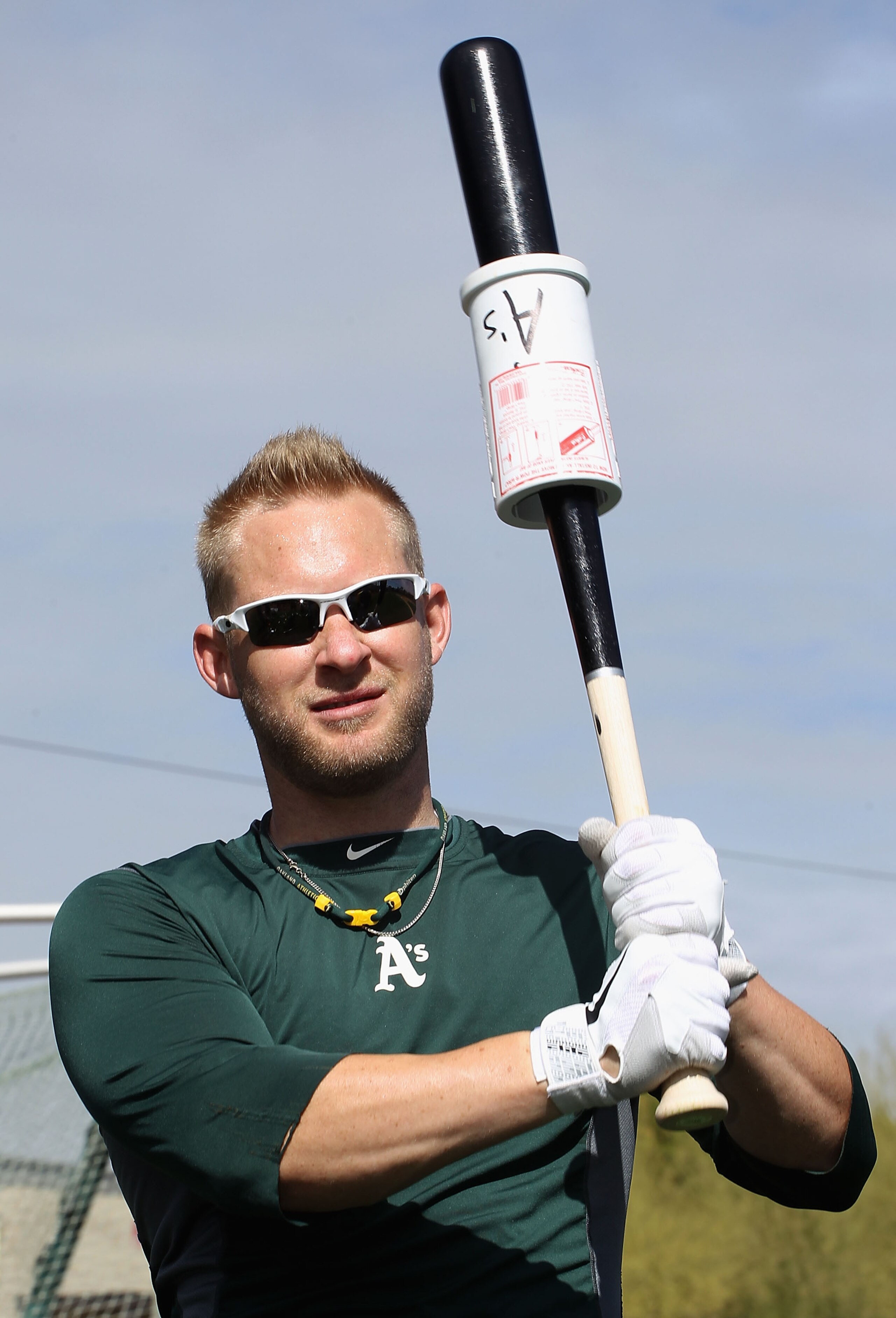 PHOENIX, AZ - FEBRUARY 16:  Daric Barton #10 of the Oakland Athletics takes batting practice during a MLB spring training practice at Phoenix Municipal Stadium on February 16, 2011 in Phoenix, Arizona.  (Photo by Christian Petersen/Getty Images)