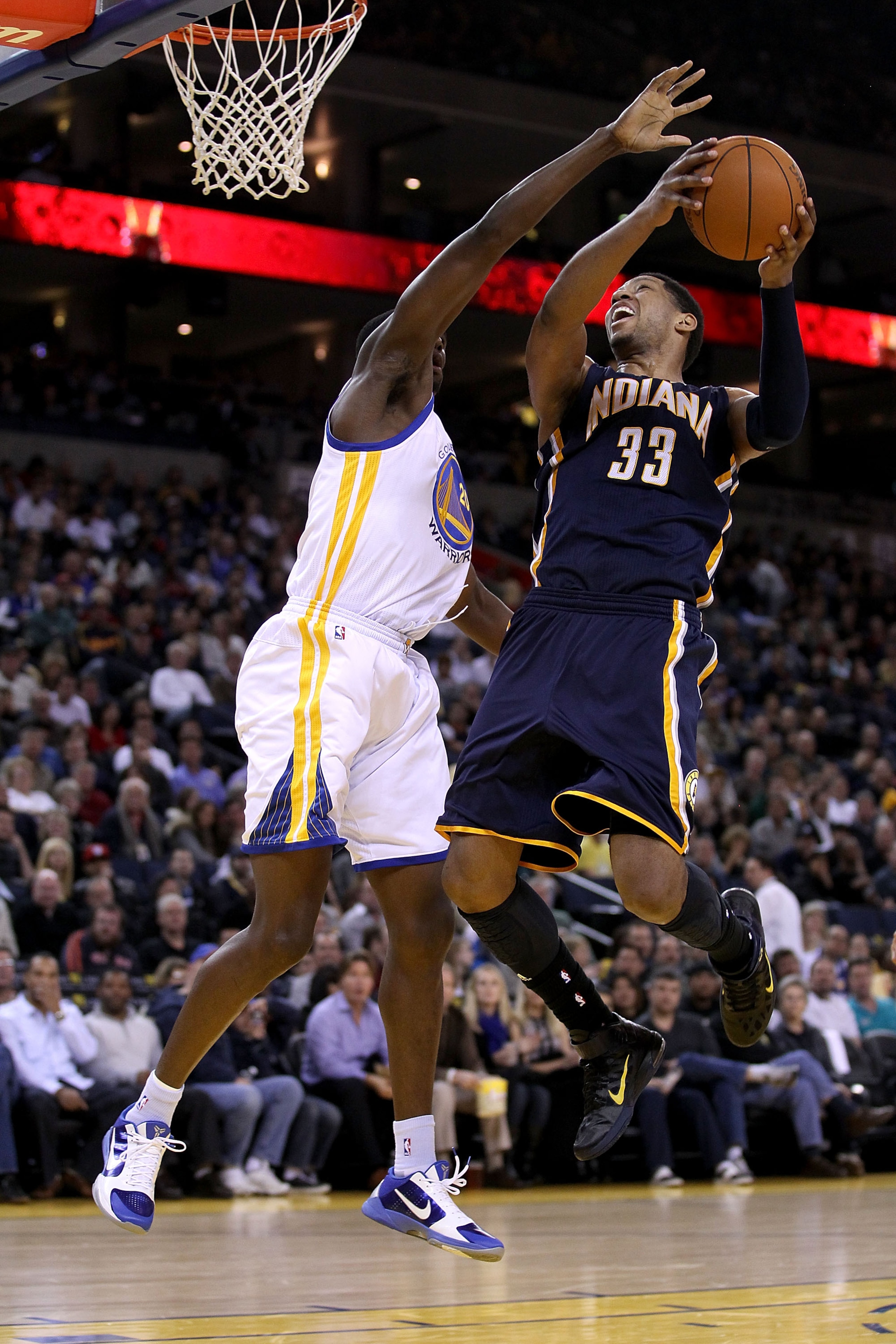 OAKLAND, CA - JANUARY 19:  Danny Granger #33 of the Indiana Pacers goes up for a shot on Ekpe Udoh #20 of the Golden State Warriors at Oracle Arena on January 19, 2011 in Oakland, California.  NOTE TO USER: User expressly acknowledges and agrees that, by