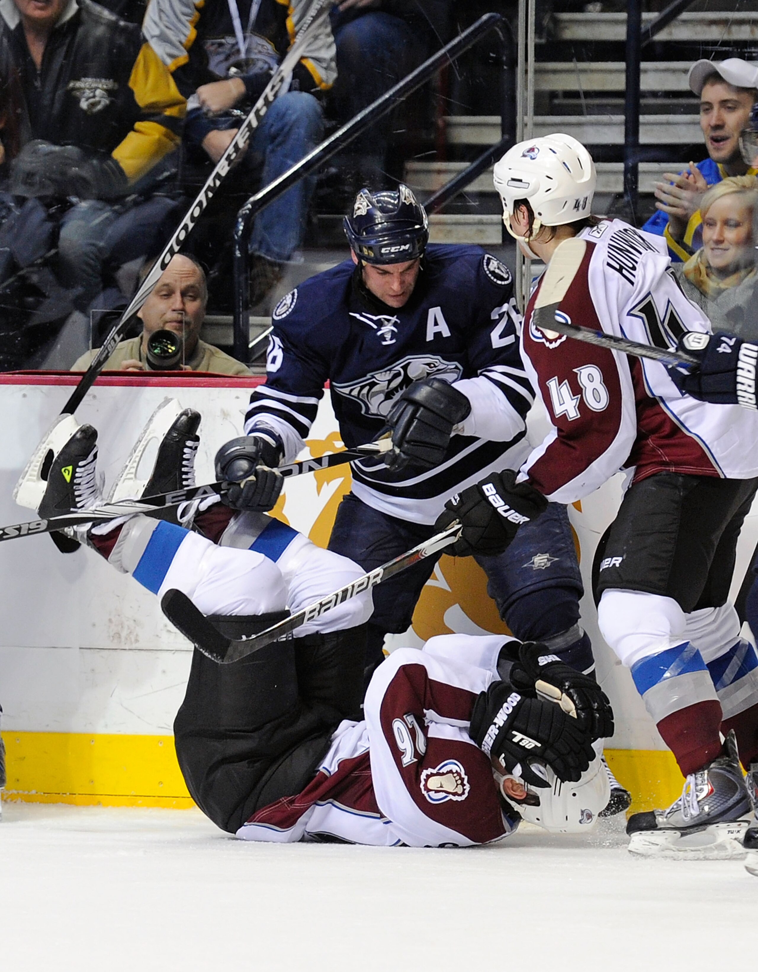 NASHVILLE, TN - FEBRUARY 12:  Paul Stastny #26 of the Colorado Avalanche is hit by Steve Sullivan #26 of the Nashville Predators on February 12, 2011 at the Bridgestone Arena in Nashville, Tennessee.  (Photo by Frederick Breedon/Getty Images)