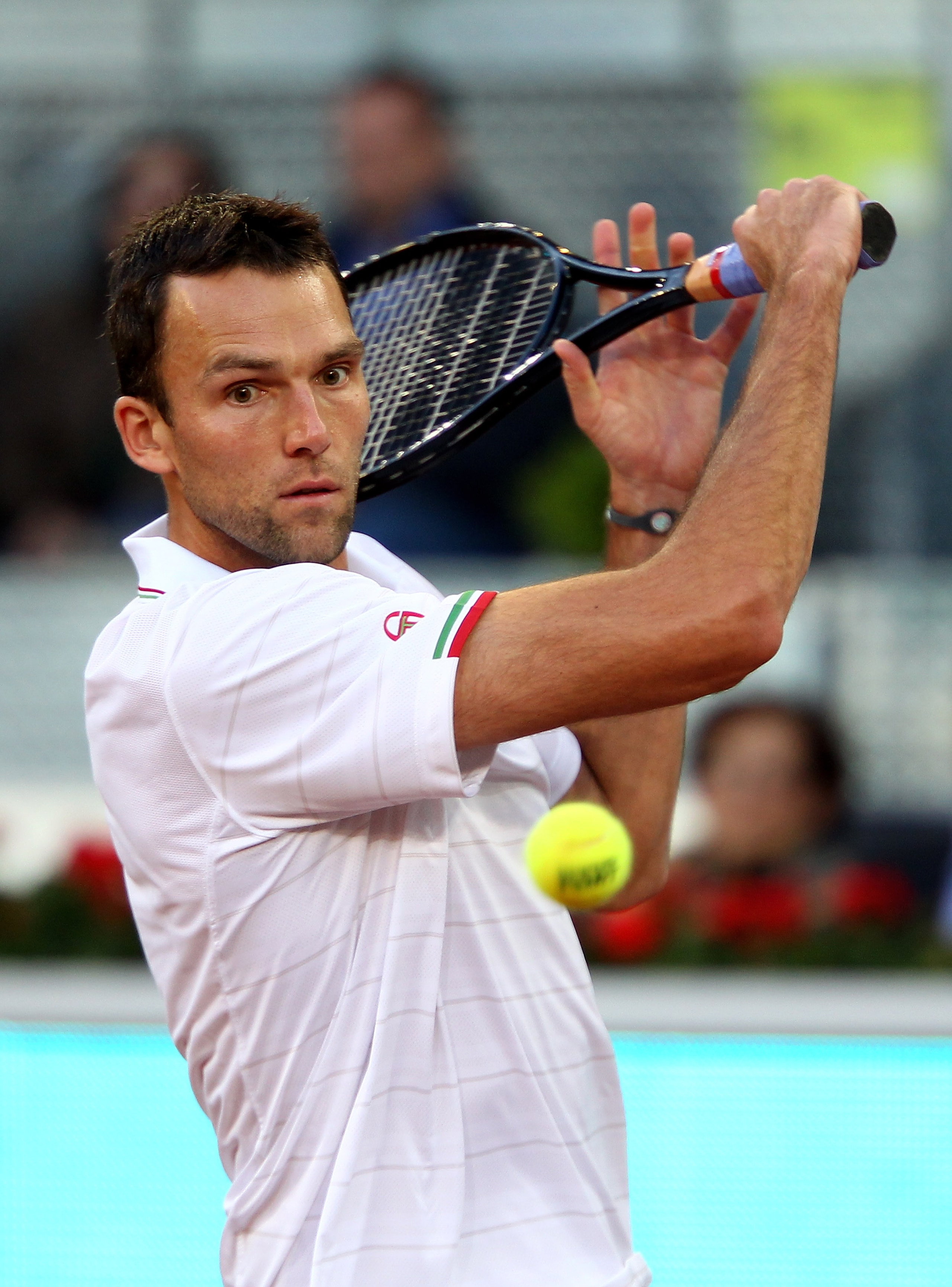 MADRID, SPAIN - MAY 11:  Ivo Karlovic of Croatia  plays a backhand against  Fernando Verdasco of Spain in their second round match during the Mutua Madrilena Madrid Open tennis tournament at the Caja Magica on on May 11, 2010 in Madrid, Spain.  (Photo by