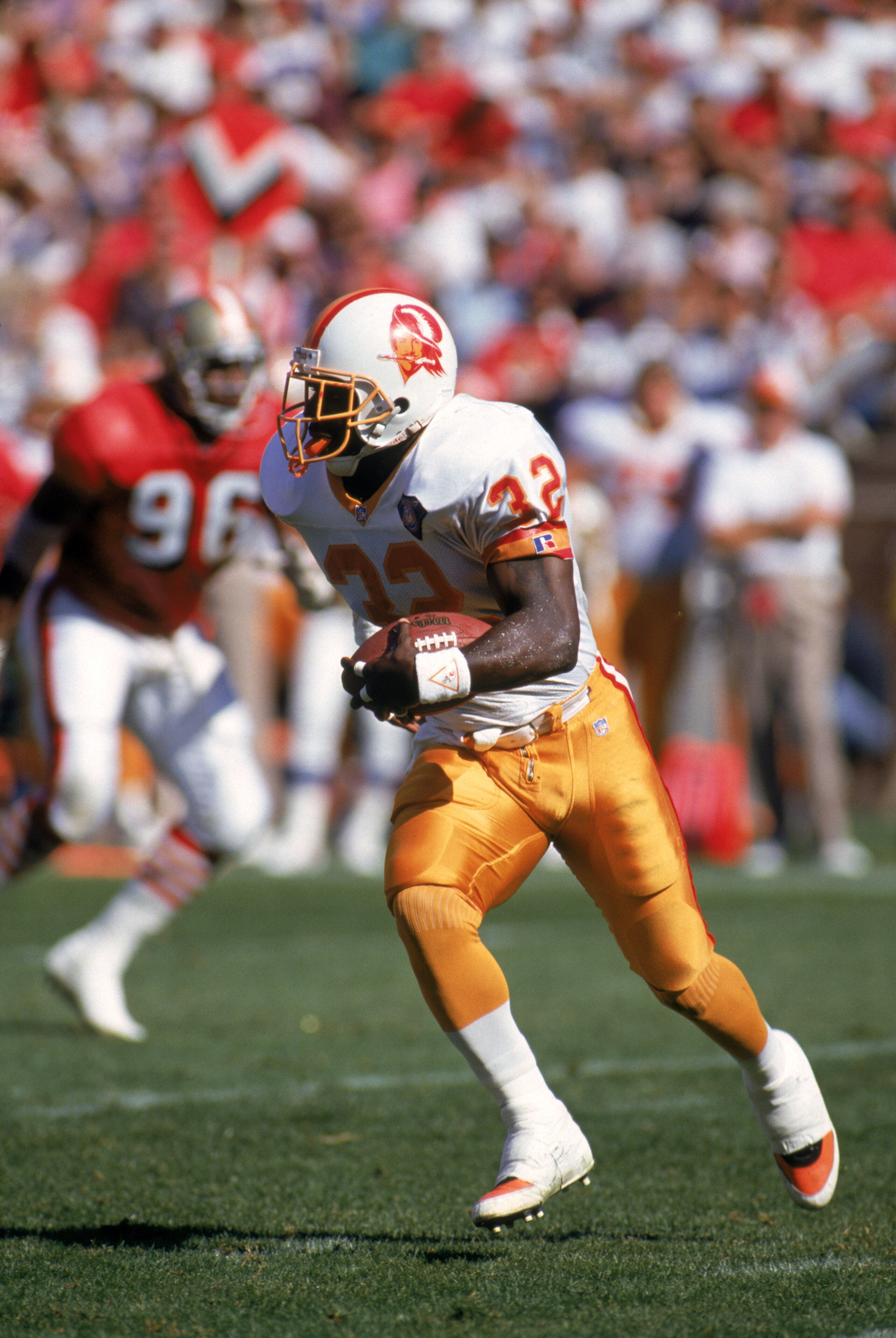 SAN FRANCISCO - OCTOBER 23:  Running back Errict Rhett #32 of the Tampa Bay Buccaneers rushes the ball up field during a game against the San Francisco 49ers at Candlestick Park on October 23, 1994 in San Francisco, California.  The 49ers won 41-16.  (Pho