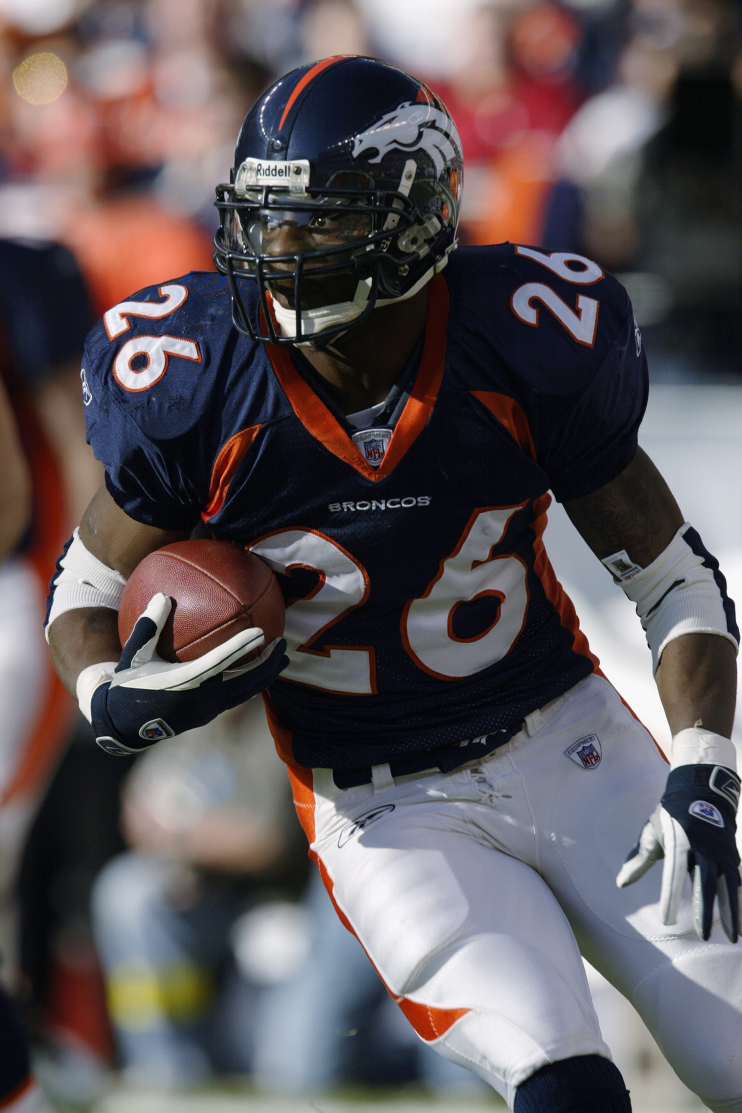DENVER - DECEMBER 29:  Running back Clinton Portis #26 of the Denver Broncos carries the ball during the game against the Arizona Cardinals at Invesco Field at Mile High on December 29, 2002 in Denver, Colorado.  The Broncos won 37-7.  (Photo by Brian Bah