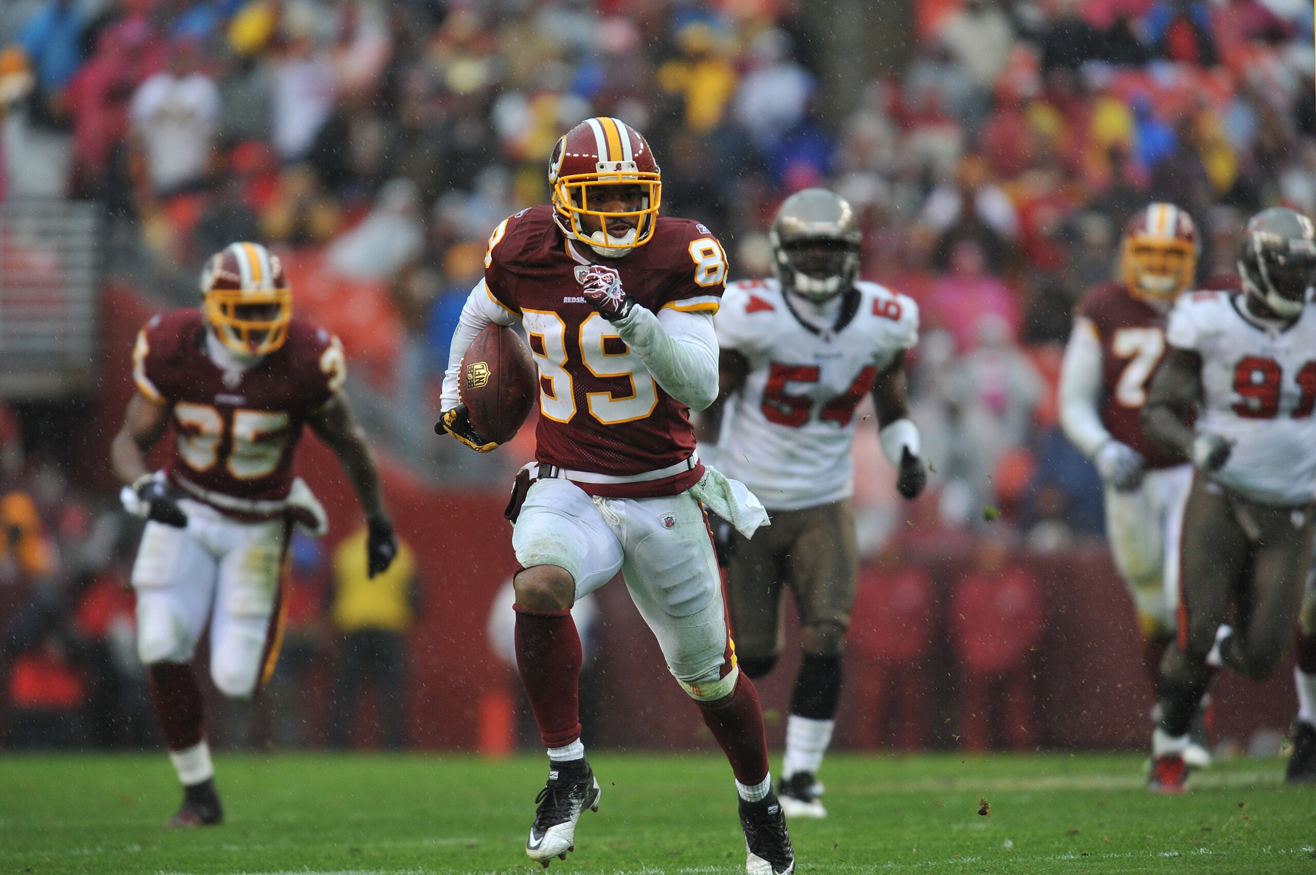 LANDOVER, MD - DECEMBER 12: Santana Moss #89 of the Washington Redskins runs the ball after a catch during the game against the Tampa Bay Buccaneers at FedExField on December 12, 2010 in Landover, Maryland. The Buccaneers defeated the Redskins 17-16. (P LANDOVER, MD - DECEMBER 12: Santana Moss #89 of the Washington Redskins runs the ball after a catch during the game against the Tampa Bay Buccaneers at FedExField on December 12, 2010 in Landover, Maryland. The Buccaneers defeated the Redskins 17-16. (P