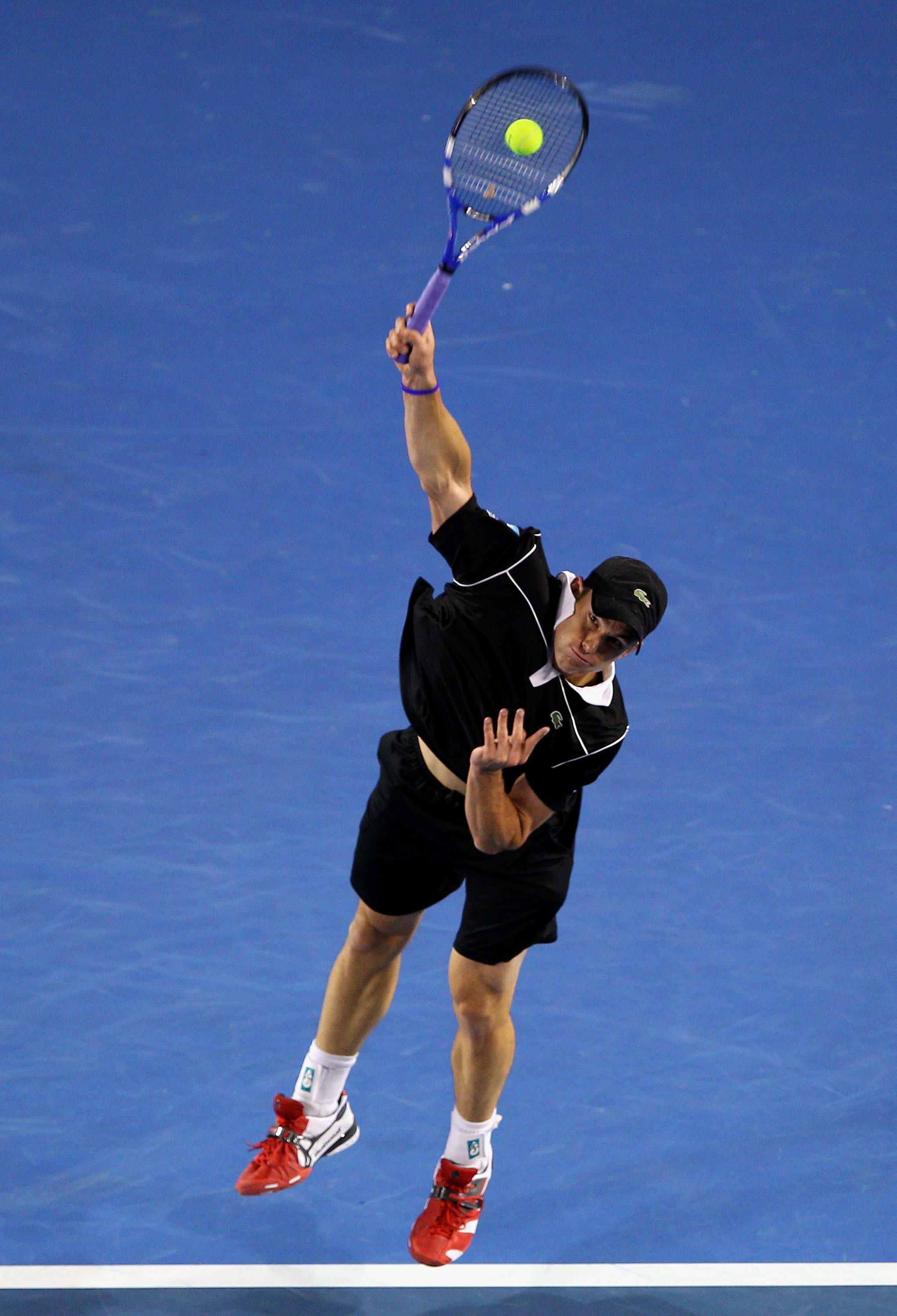 MELBOURNE, AUSTRALIA - JANUARY 23:  Andy Roddick of the United States of America serves in his fourth round match against Stanislas Wawrinka of Switzerland during day seven of the 2011 Australian Open at Melbourne Park on January 23, 2011 in Melbourne, Au
