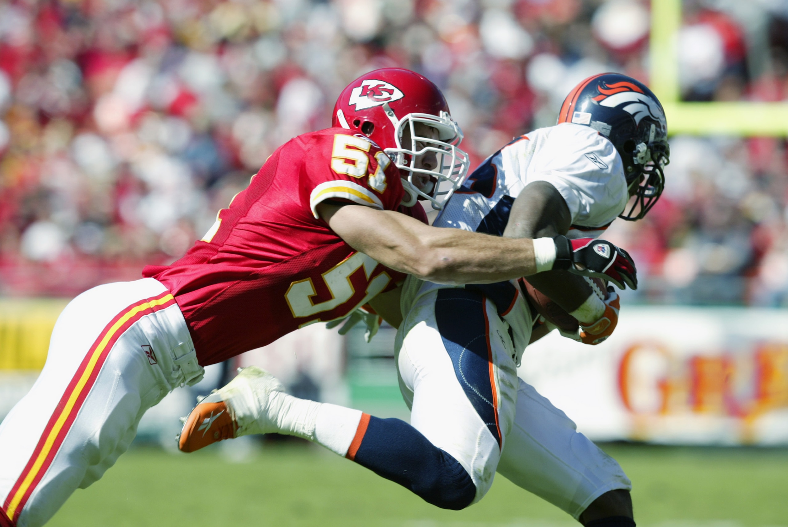 KANSAS CITY, MO - OCTOBER 20:  Scott Fujita #51 of the Kansas City Chiefs takes down Clinton Portis #26 of the Denver Broncos in the first half of the NFL game at Arrowhead Stadium in Kansas City, Missouri on October 20, 2002.  The Broncos defeated the Ch