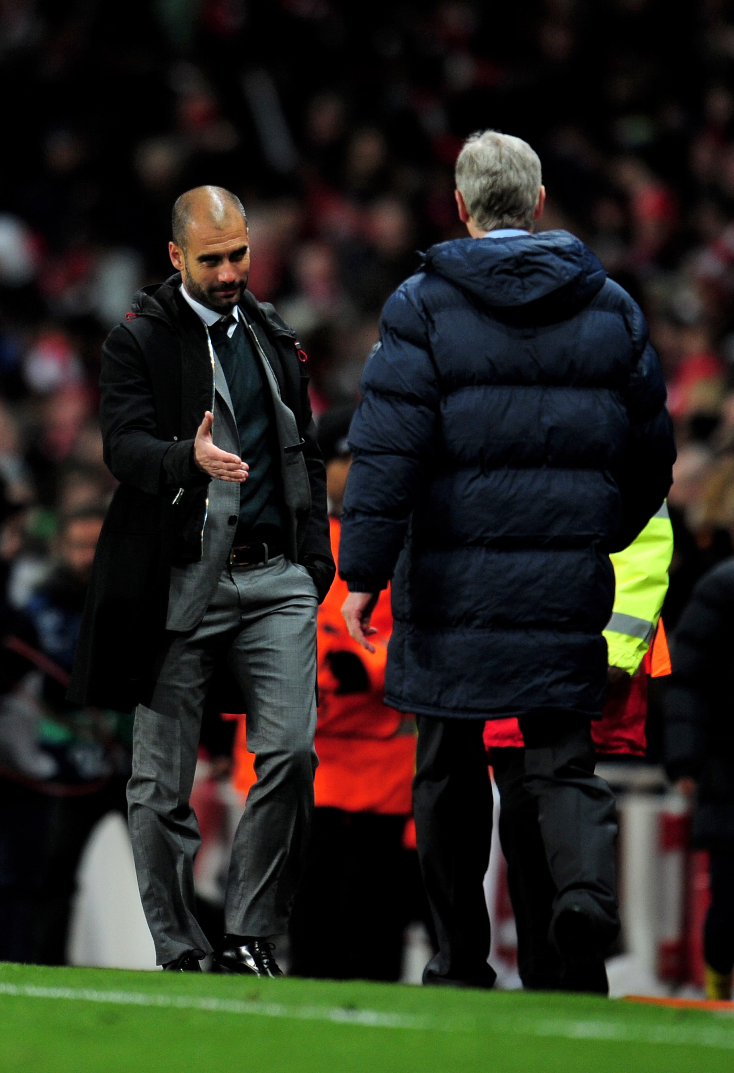 LONDON, ENGLAND - MARCH 31:  Pep Guardiola (L) the Barcelona manager shakes hands with Arsene Wenger the Arsenal manager following their teams' 2-2 draw during the UEFA Champions League quarter final first leg match between Arsenal and FC Barcelona at the