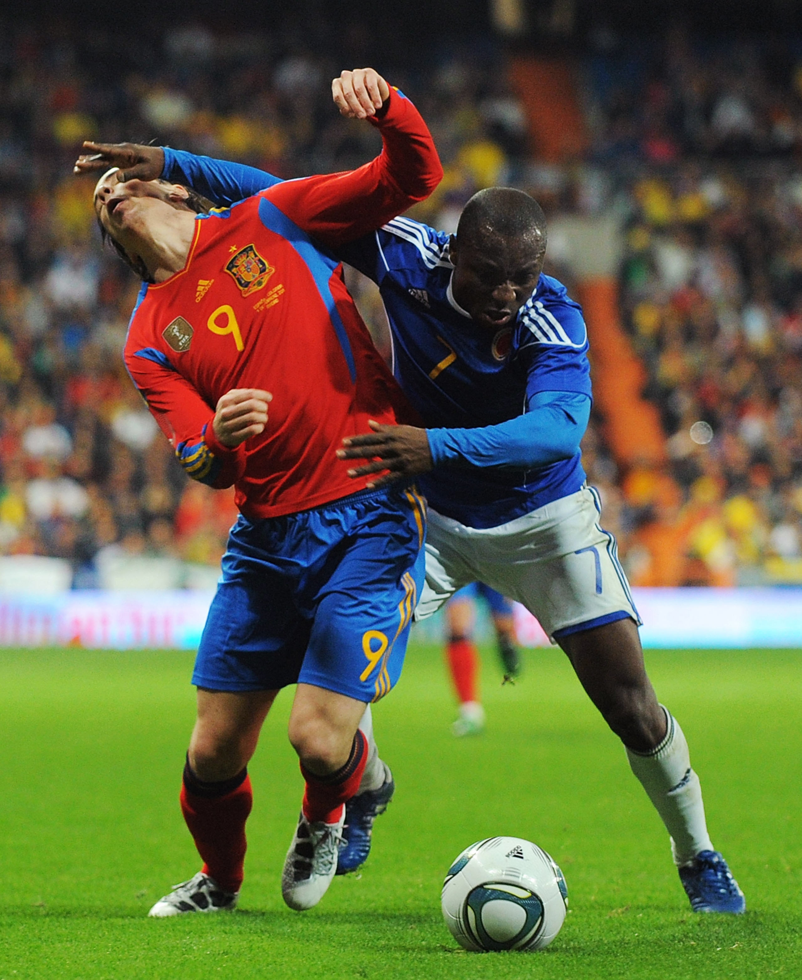 MADRID, SPAIN - FEBRUARY 09:  Fernando Torres (L)  of Spain is fouled by Armero of Colombia during the International friendly match between Spain and Colombia at Estadio Santiago Bernabeu on February 9, 2011 in Madrid, Spain.  (Photo by Denis Doyle/Getty