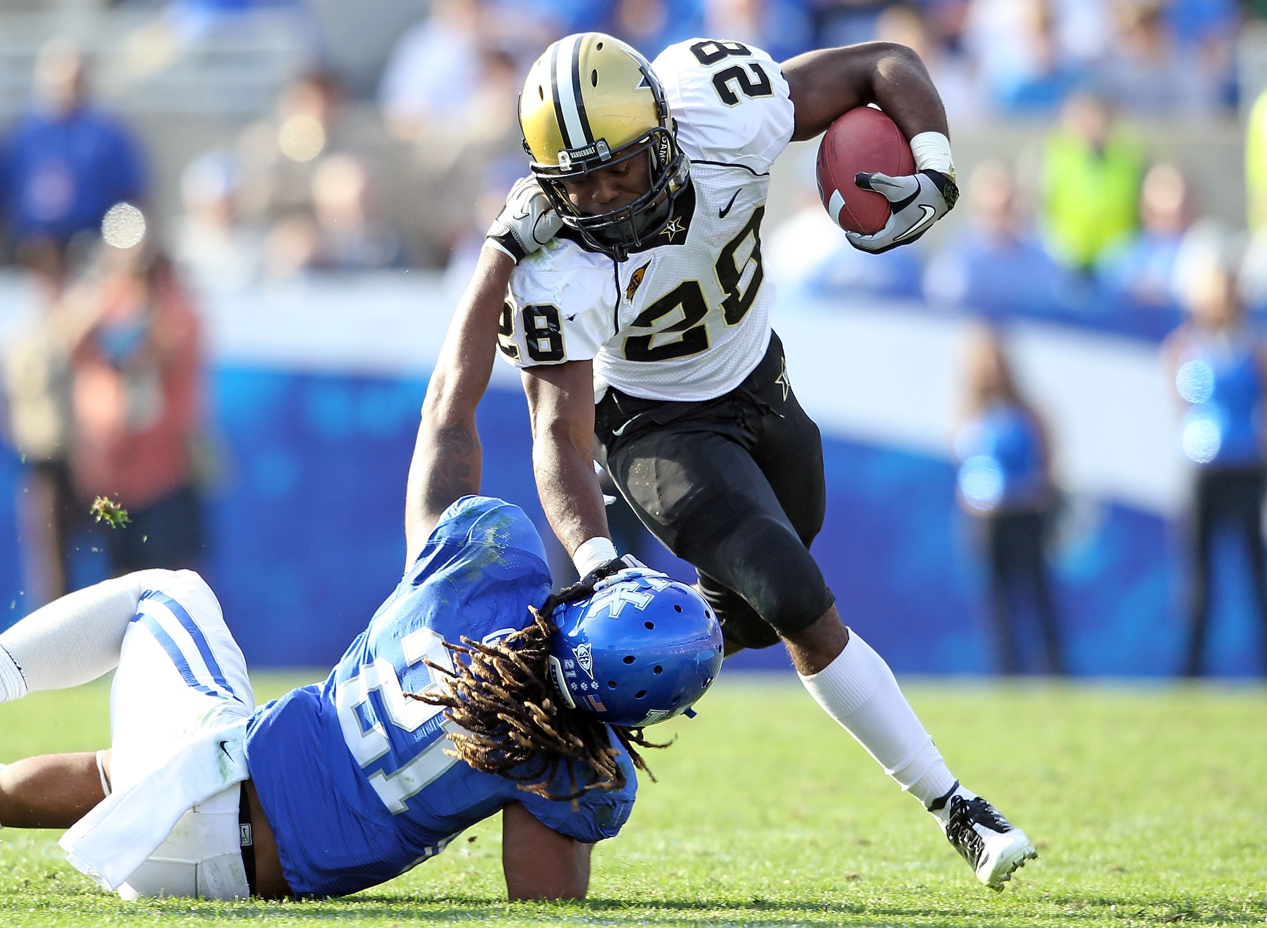 LEXINGTON, KY - NOVEMBER 13:  Kennard Reeves # 28 of the Vanderbilt Commodores is tackled by Winston Guy #21 of the Kentucky Wildcats during the game at Commonwealth Stadium on November 13, 2010 in Lexington, Kentucky.  (Photo by Andy Lyons/Getty Images)