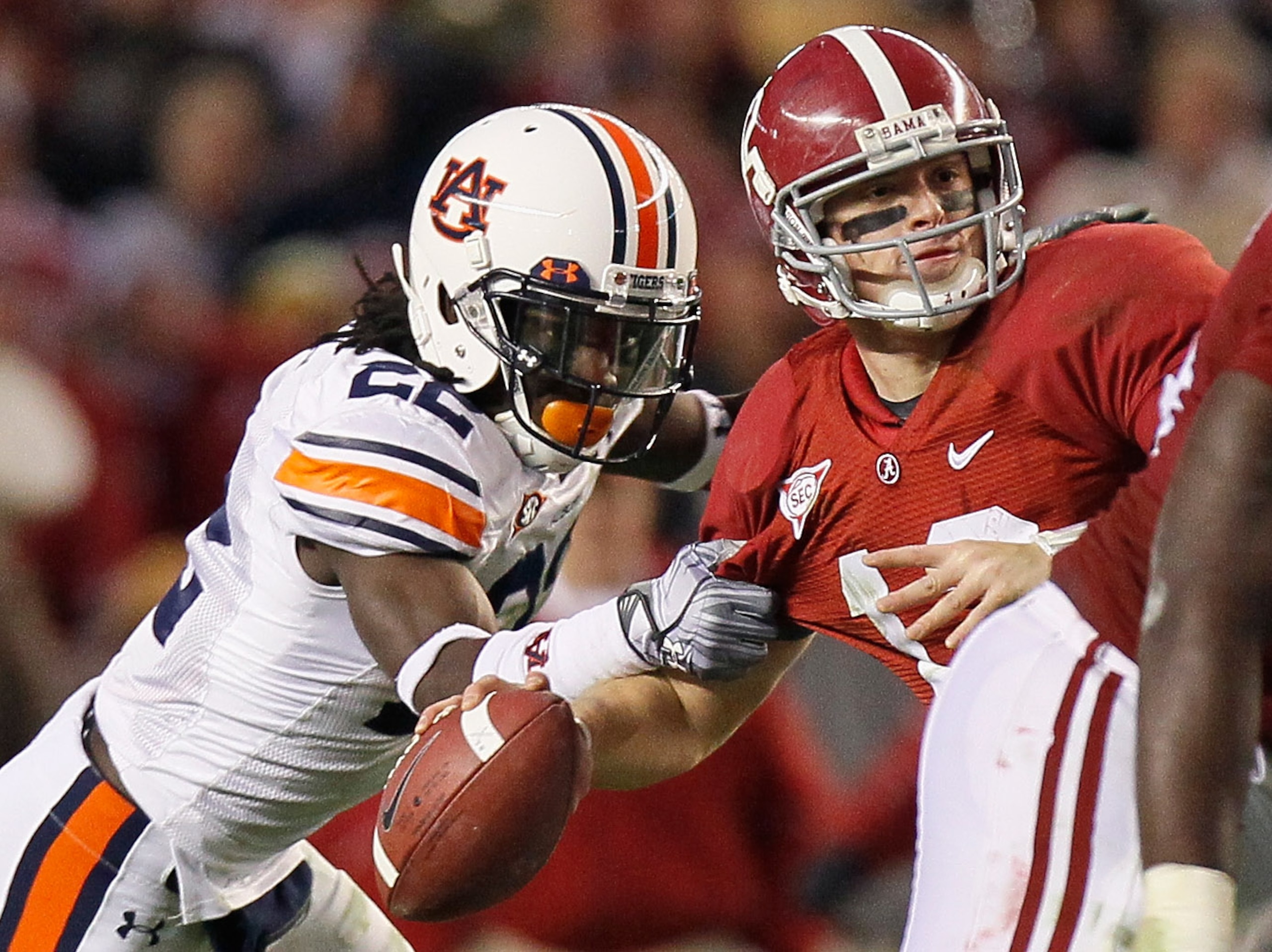 TUSCALOOSA, AL - NOVEMBER 26: T'Sharvan Bell #22 of the Auburn Tigers sacks quarterback Greg McElroy #12 of the Alabama Crimson Tide at Bryant-Denny Stadium on November 26, 2010 in Tuscaloosa, Alabama. McElroy was injured on this sack. (Photo by Kevin TUSCALOOSA, AL - NOVEMBER 26: T'Sharvan Bell #22 of the Auburn Tigers sacks quarterback Greg McElroy #12 of the Alabama Crimson Tide at Bryant-Denny Stadium on November 26, 2010 in Tuscaloosa, Alabama. McElroy was injured on this sack. (Photo by Kevin