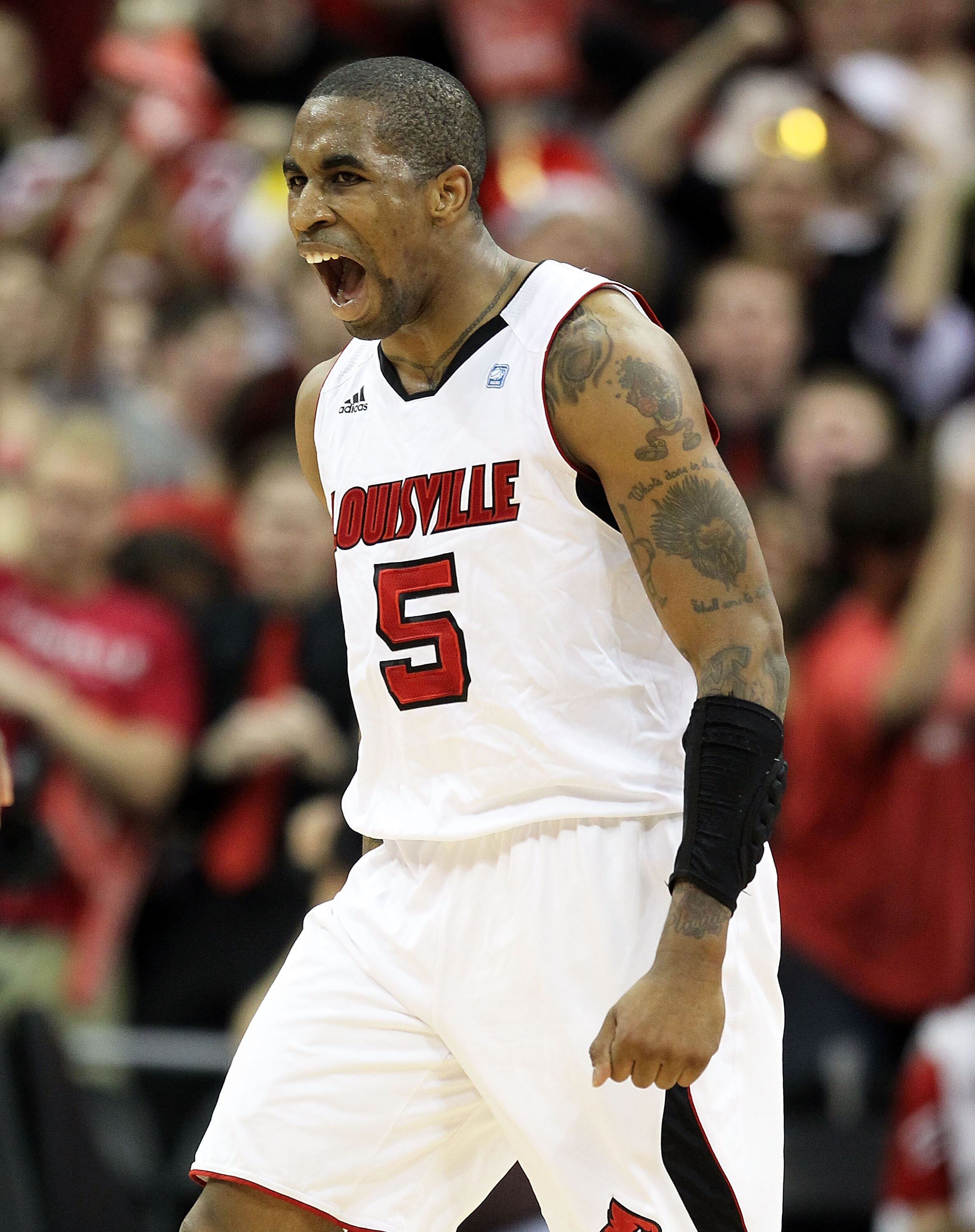 LOUISVILLE, KY - FEBRUARY 18: Chris Smith #5 of the Louisville Cardinals celebrates during the Big East Conference game against the Connecticut Huskies at the KFC Yum! Center on February 18, 2011 in Louisville, Kentucky.  (Photo by Andy Lyons/Getty Images