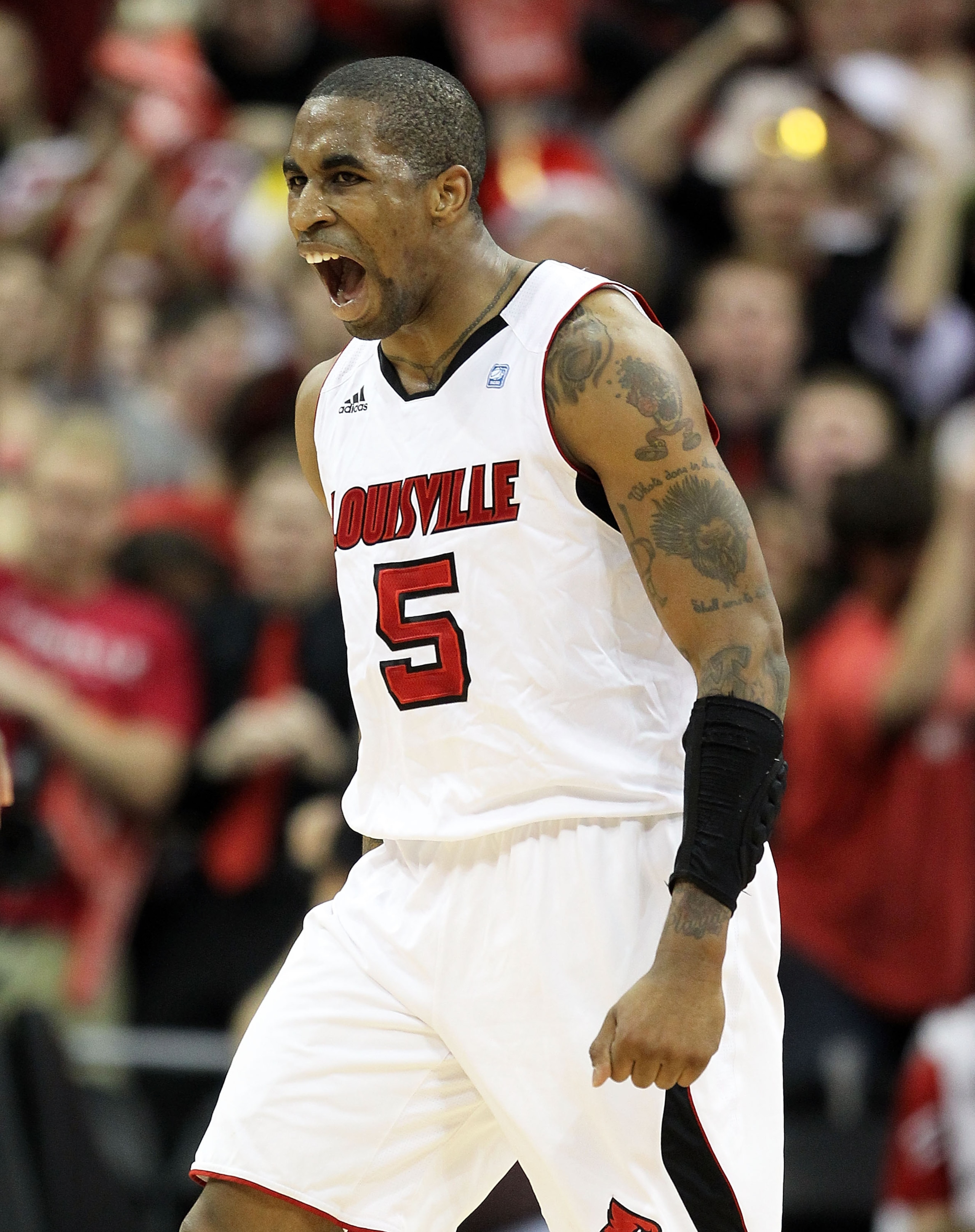 LOUISVILLE, KY - FEBRUARY 18: Chris Smith #5 of the Louisville Cardinals celebrates during the Big East Conference game against the Connecticut Huskies at the KFC Yum! Center on February 18, 2011 in Louisville, Kentucky.  (Photo by Andy Lyons/Getty Images