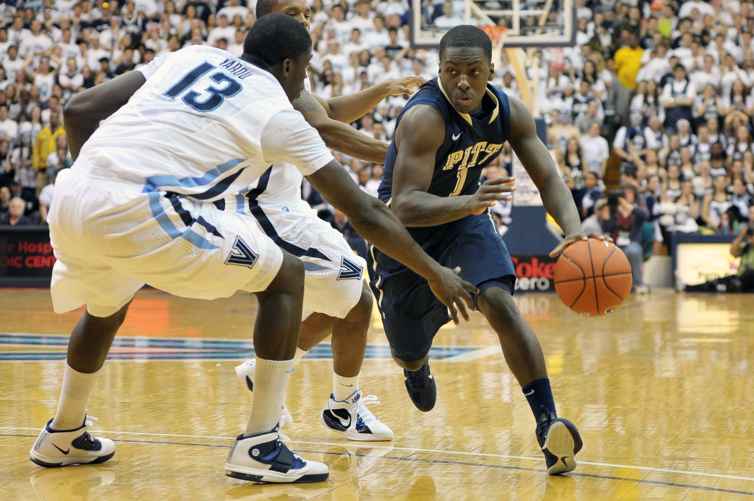 VILLANOVA, PA - FEBRUARY 12: Travon Woodall #1 of the Pittsburgh Panthers drives around Mouphtaou Yarou #13 of the Villanova Wildcats at The Pavilion on February 12, 2011 in Villanova, Pennsylvania. (Photo by Drew Hallowell/Getty Images)