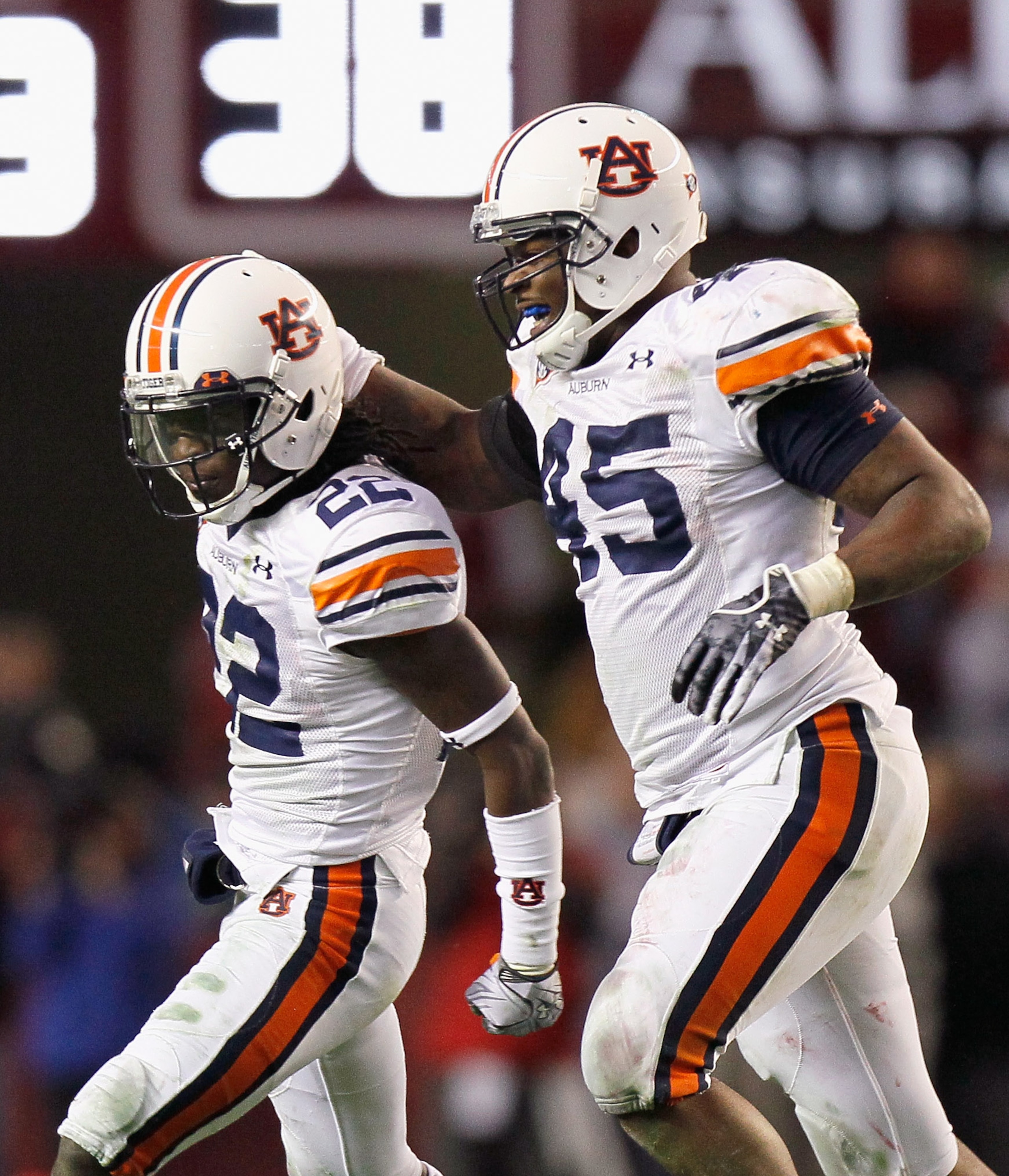 TUSCALOOSA, AL - NOVEMBER 26: T'Sharvan Bell #22 and Antoine Carter #45 of the Auburn Tigers celebrate after Bell sacked quarterback Greg McElroy #12 of the Alabama Crimson Tide at Bryant-Denny Stadium on November 26, 2010 in Tuscaloosa, Alabama. McElro TUSCALOOSA, AL - NOVEMBER 26: T'Sharvan Bell #22 and Antoine Carter #45 of the Auburn Tigers celebrate after Bell sacked quarterback Greg McElroy #12 of the Alabama Crimson Tide at Bryant-Denny Stadium on November 26, 2010 in Tuscaloosa, Alabama. McElro