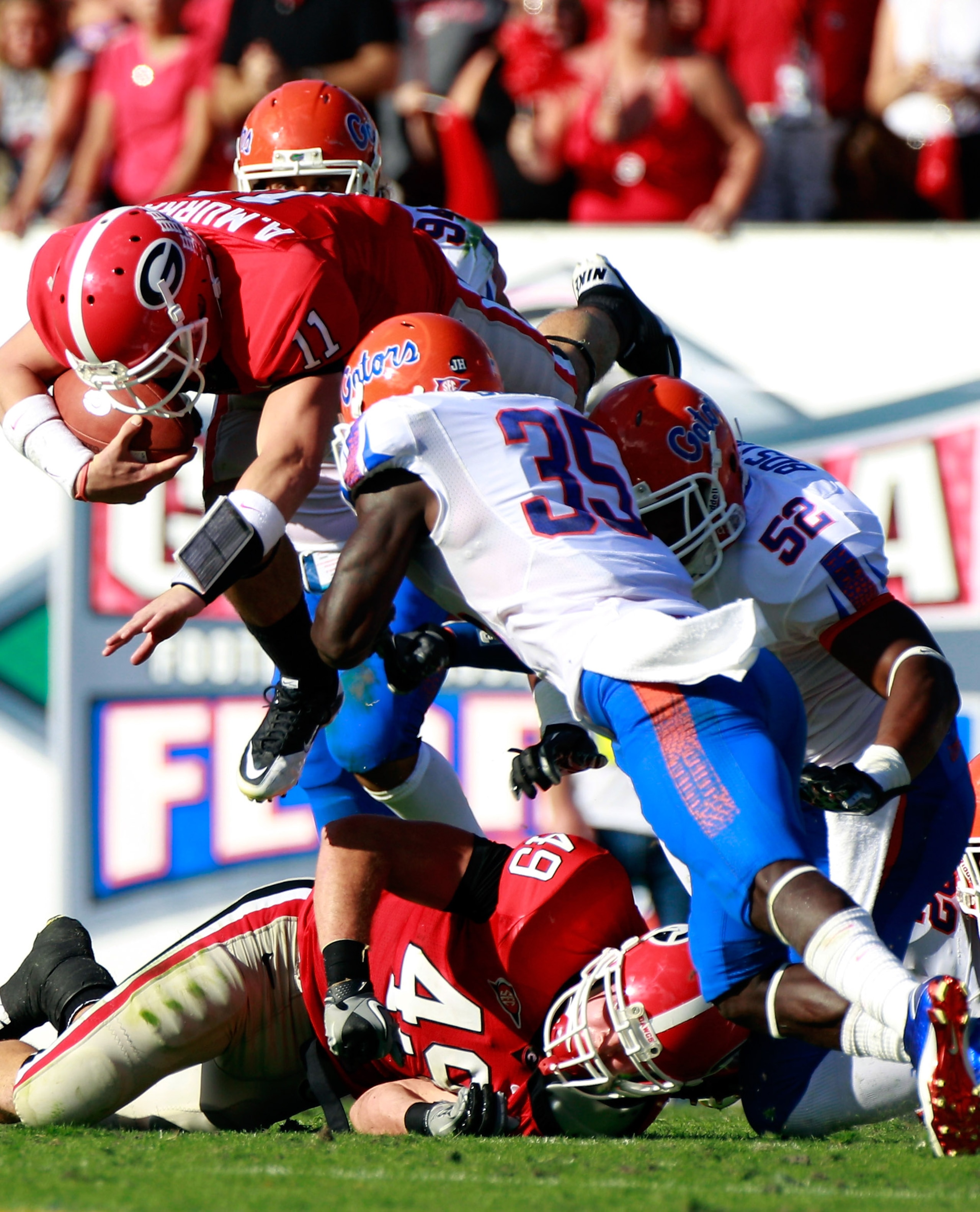 JACKSONVILLE, FL - OCTOBER 30:  Ahmad Black #35 of the Florida Gators tackles Aaron Murray #11 of the Georgia Bulldogs during the game at EverBank Field on October 30, 2010 in Jacksonville, Florida.  (Photo by Sam Greenwood/Getty Images)