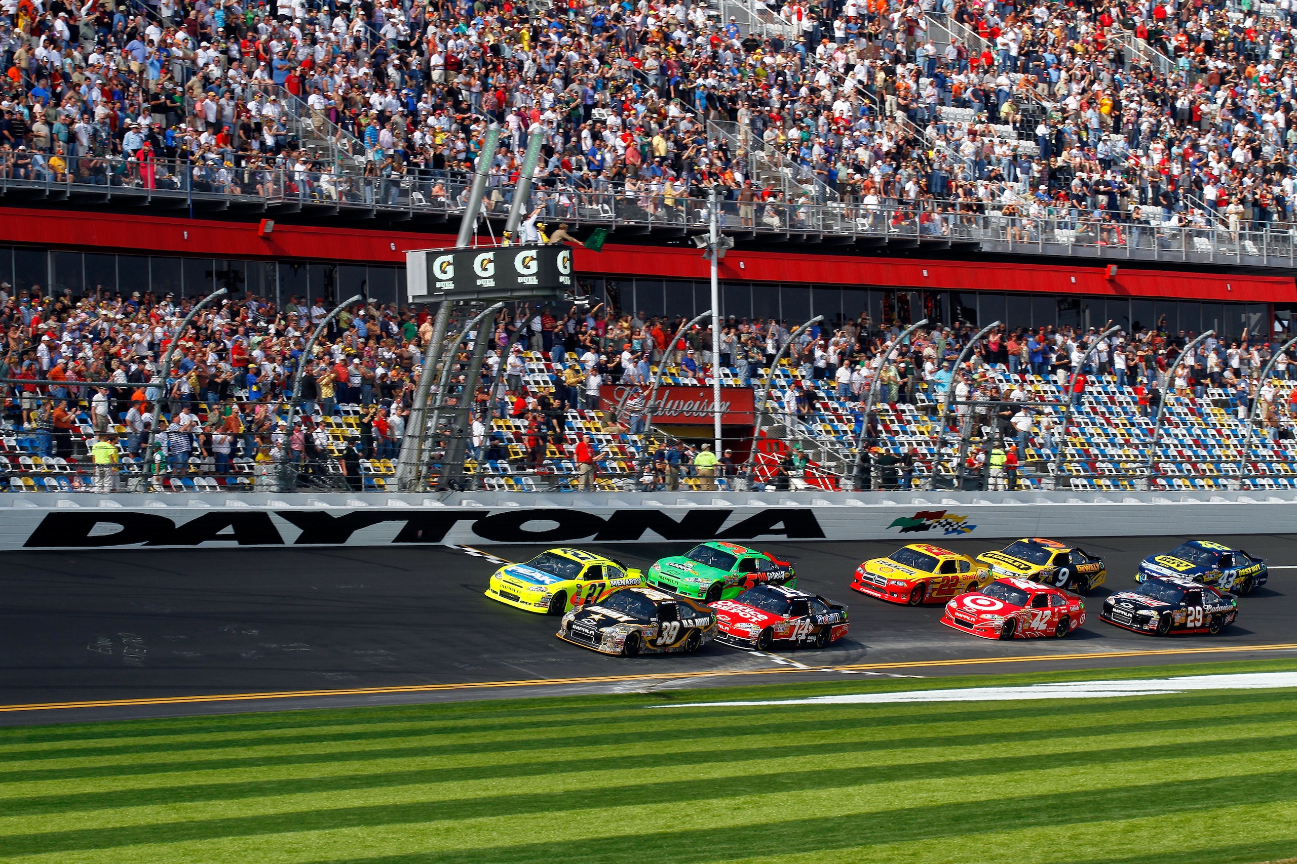 DAYTONA BEACH, FL - FEBRUARY 17:  Ryan Newman, driver of the #39 U.S. Army Chevrolet, and Paul Menard, driver of the #27 Menards Chevrolet,  lead the field to the green flag to start the first race of the NASCAR Sprint Cup Series Gatorade Duel at Daytona