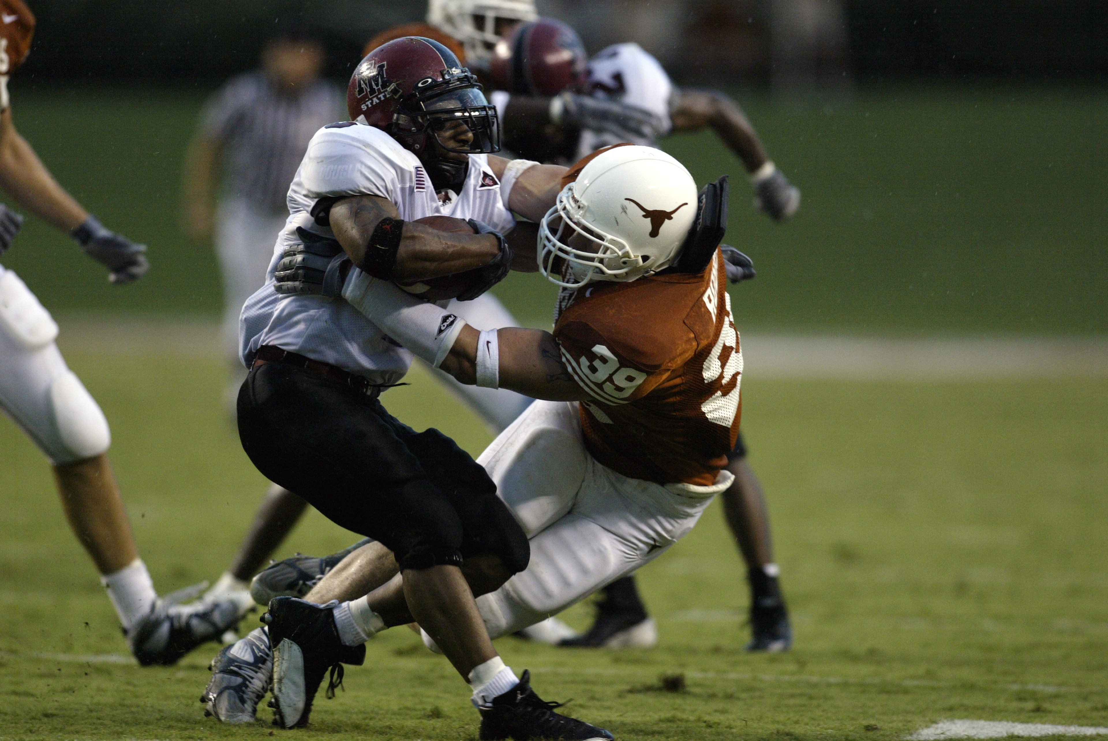 AUSTIN, TX - AUGUST 31: Linebacker Brian Robison #39 of the University of Texas at Austin Longhorns tackles Keith Mouton #6 of the New Mexico State University Aggies at Texas Memorial Stadium on August 31, 2003 in Austin, Texas. Texas defeated New Mexico AUSTIN, TX - AUGUST 31: Linebacker Brian Robison #39 of the University of Texas at Austin Longhorns tackles Keith Mouton #6 of the New Mexico State University Aggies at Texas Memorial Stadium on August 31, 2003 in Austin, Texas. Texas defeated New Mexico